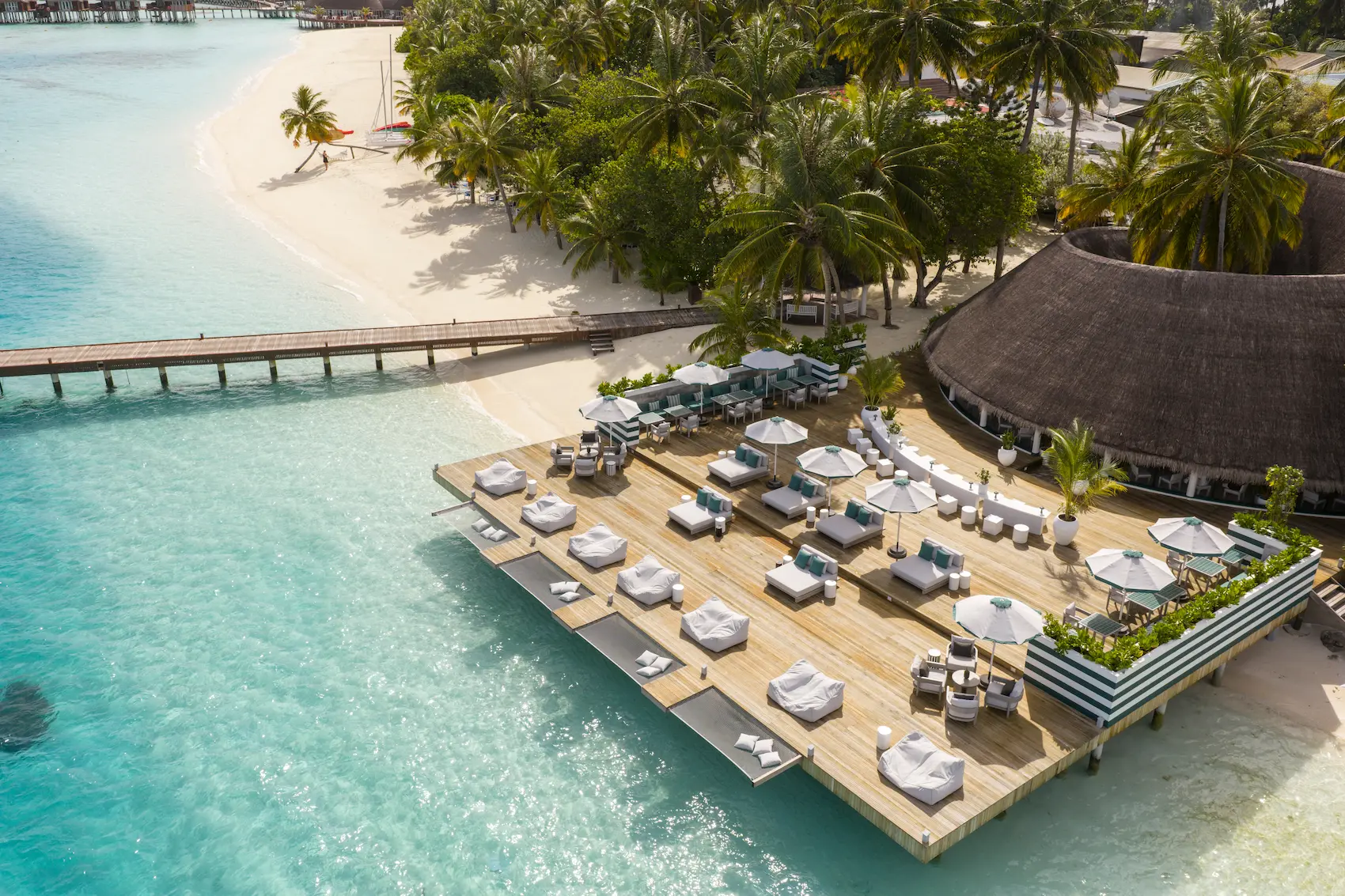 sun siyam vilu reef maldives nautilus bar interior and exterior featuring relaxed open air design beside the lagoon