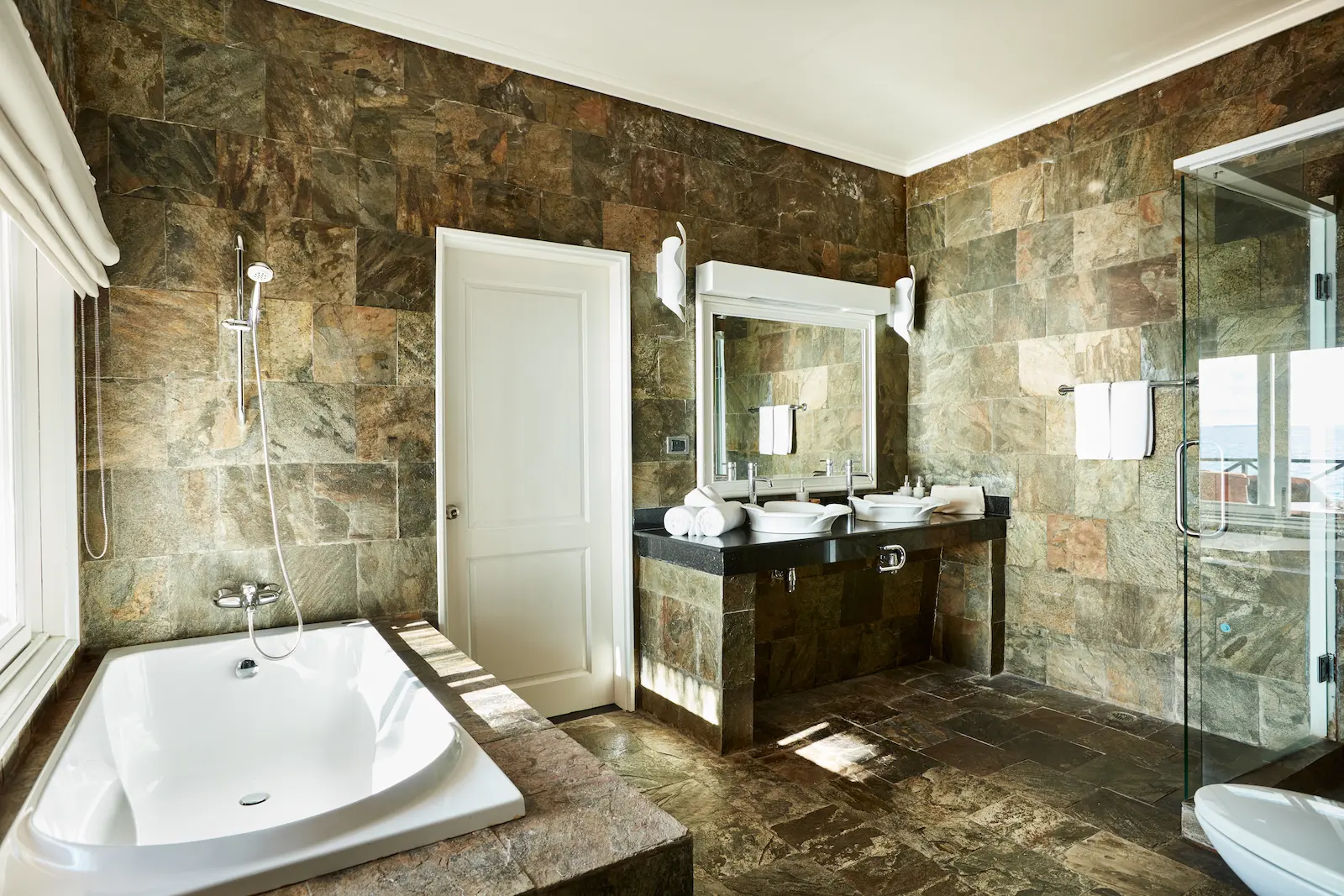 sun siyam vilu reef maldives sunset reef villa bathroom featuring elegant finishes and a serene overwater atmosphere