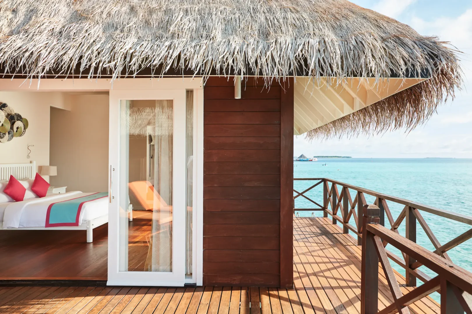 sun siyam vilu reef maldives sunset reef villa exterior set above the turquoise lagoon with unobstructed ocean views
