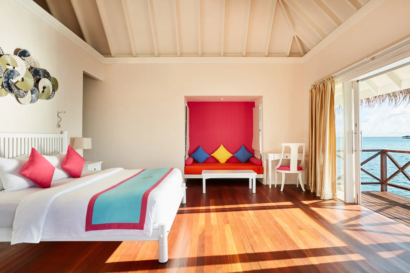 sun siyam vilu reef maldives sunset reef villa interior showcasing refined furnishings natural textures and a calm overwater atmosphere