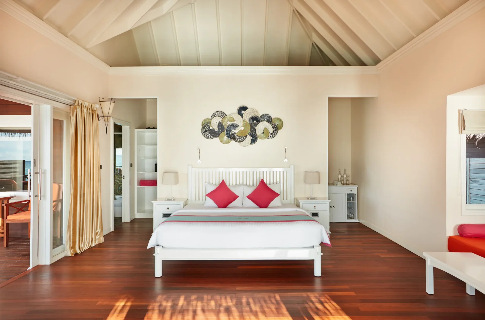 sun siyam vilu reef maldives sunset villa bedroom featuring refined interiors soft natural light and a warm tropical ambience