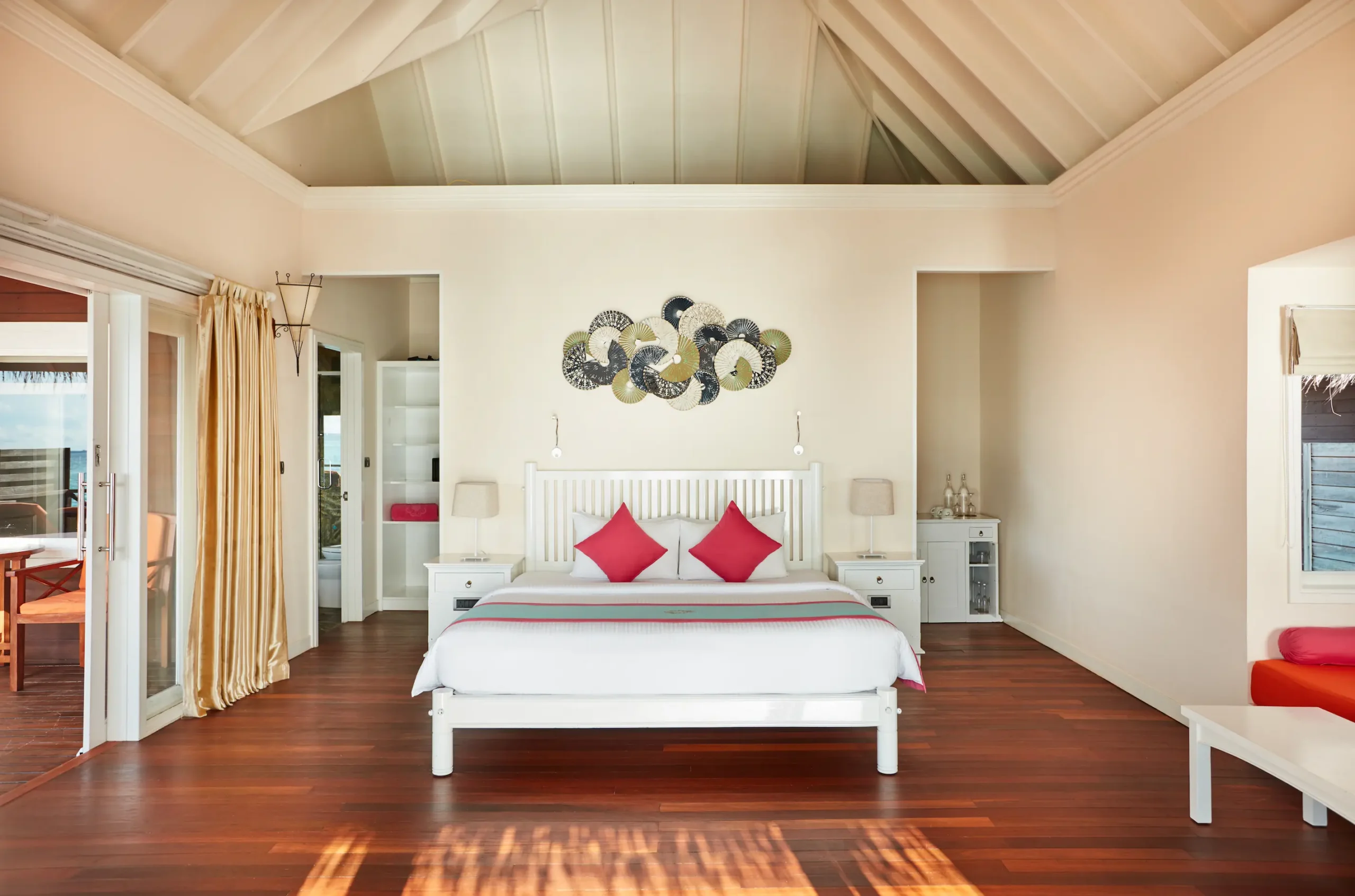 sun siyam vilu reef maldives sunset villa bedroom featuring refined interiors soft natural light and a warm tropical ambience