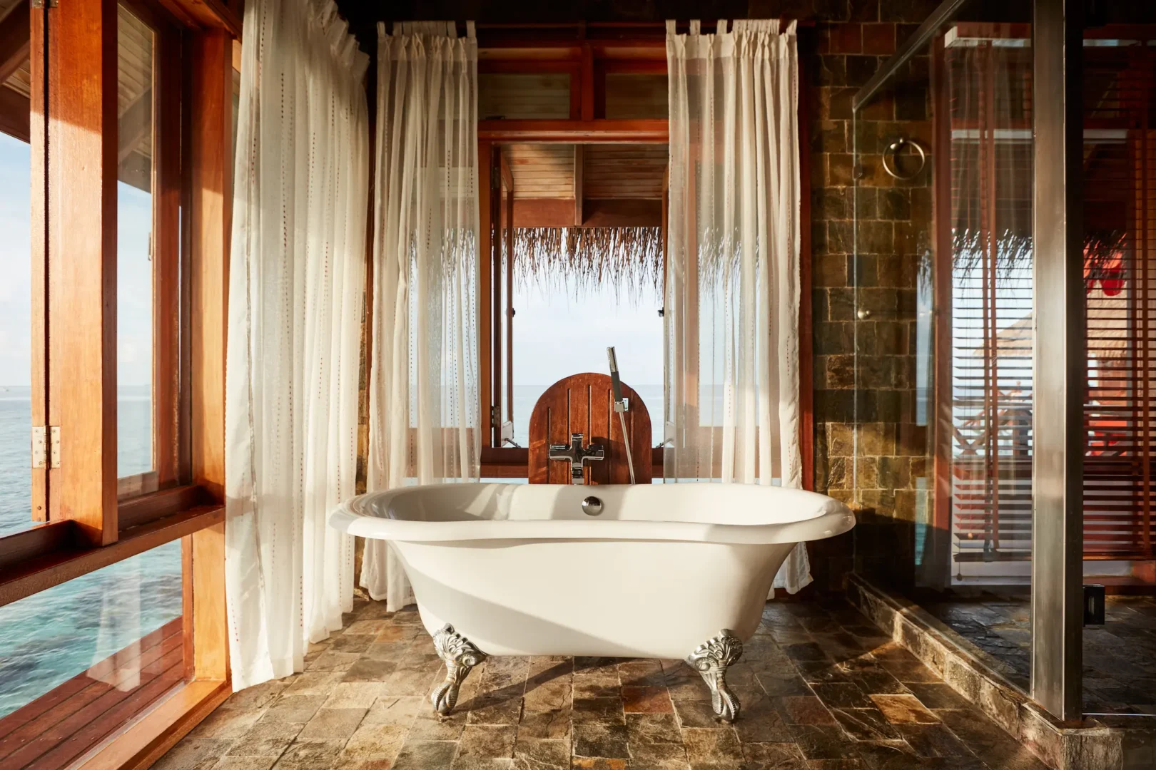 sun siyam vilu reef maldives two bedroom water villa with pool bathroom featuring elegant finishes and a serene overwater atmosphere