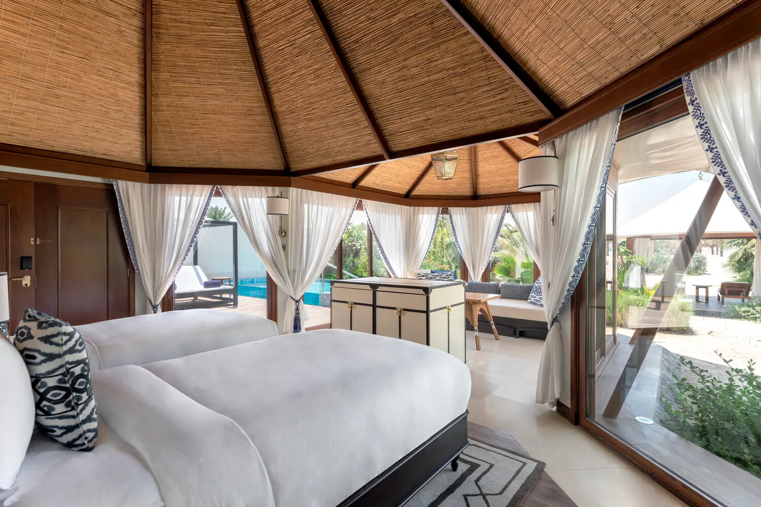 the ritzcarlton al hamra beach al bahar tented villa bedroom featuring an elegant bedroom space with refined coastal styling