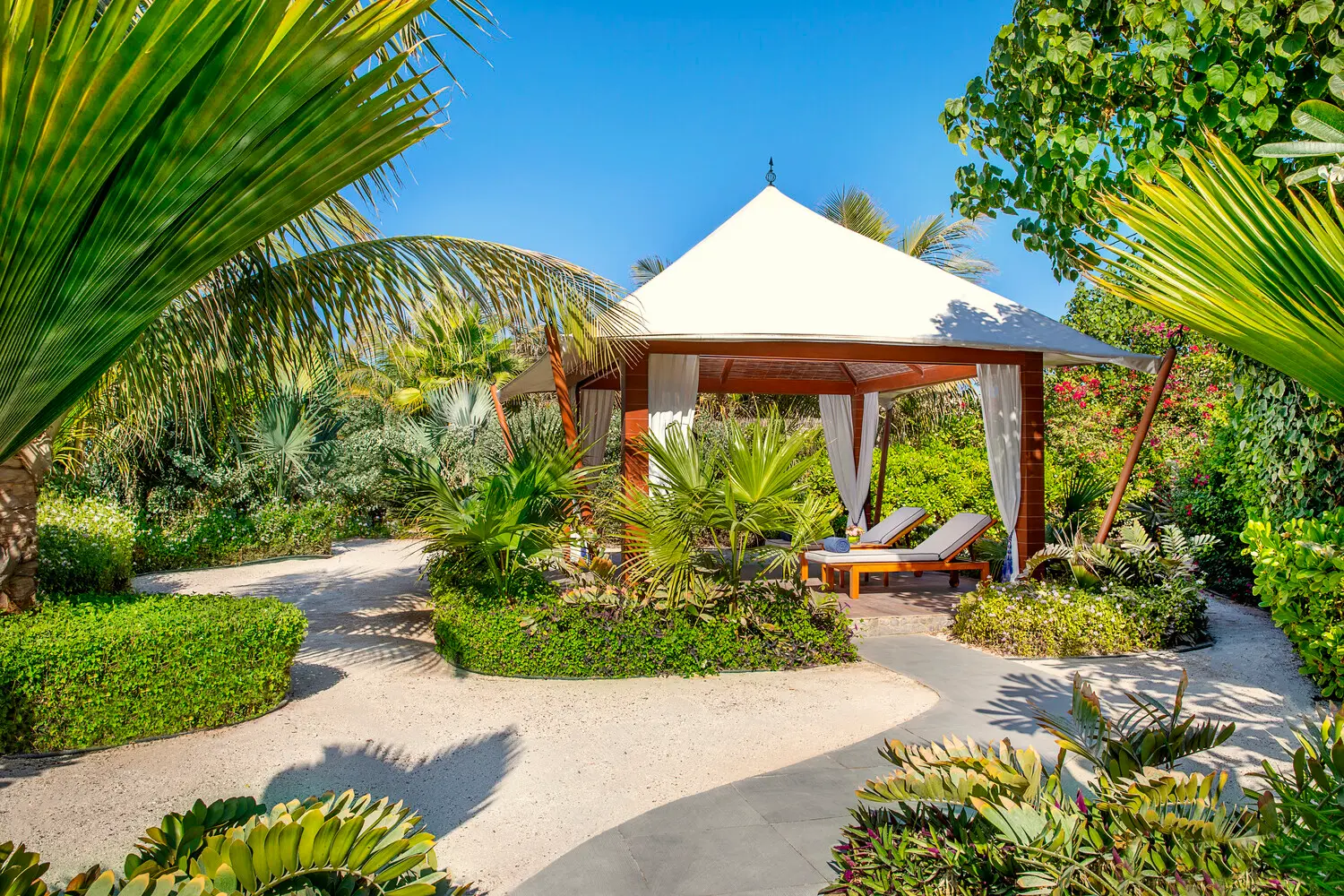 the ritzcarlton al hamra beach al naseem tented villa pool cabana offering a shaded poolside space designed for relaxed coastal living