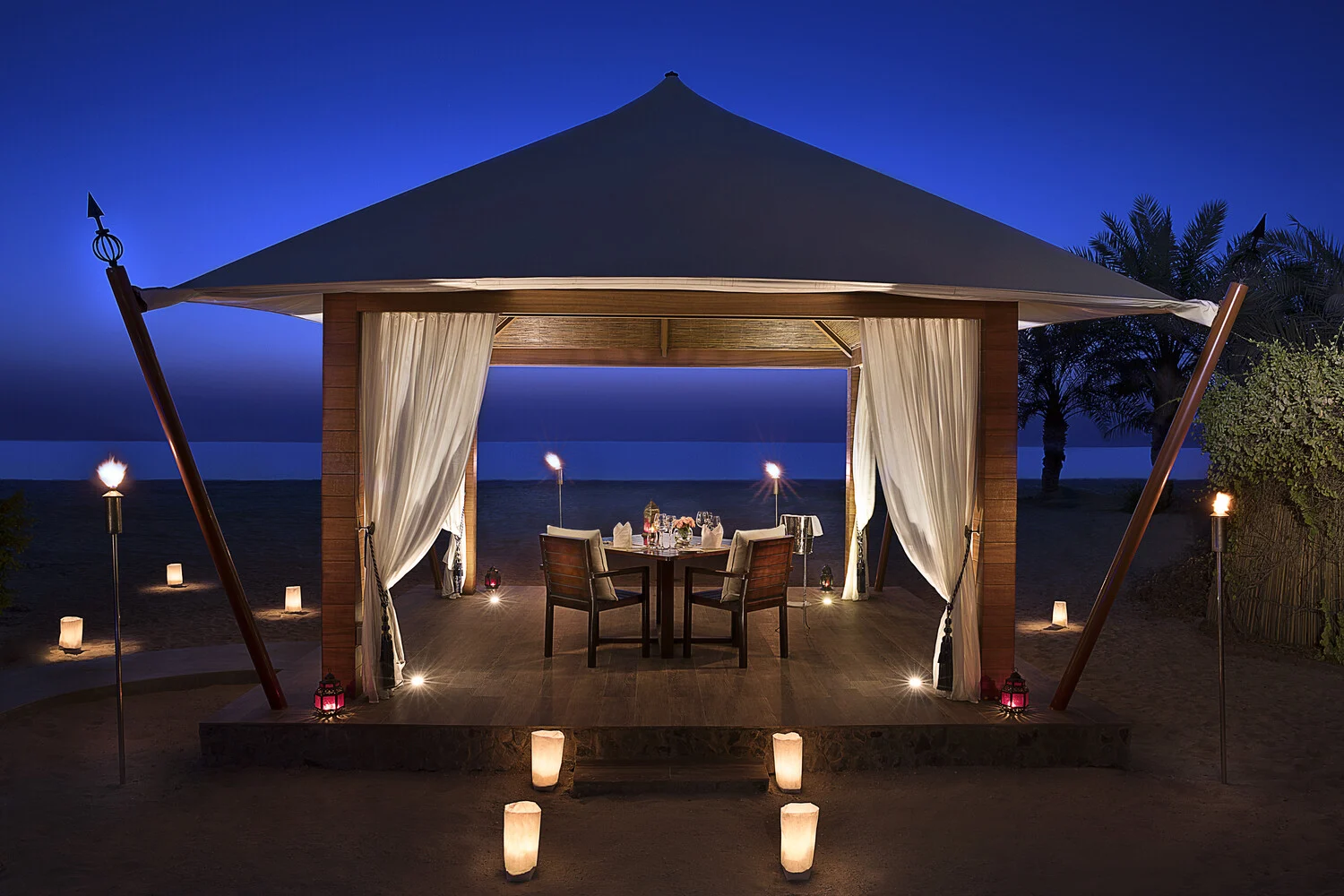 the ritzcarlton al hamra beach destination dining offering an intimate private dining experience set within a scenic coastal setting