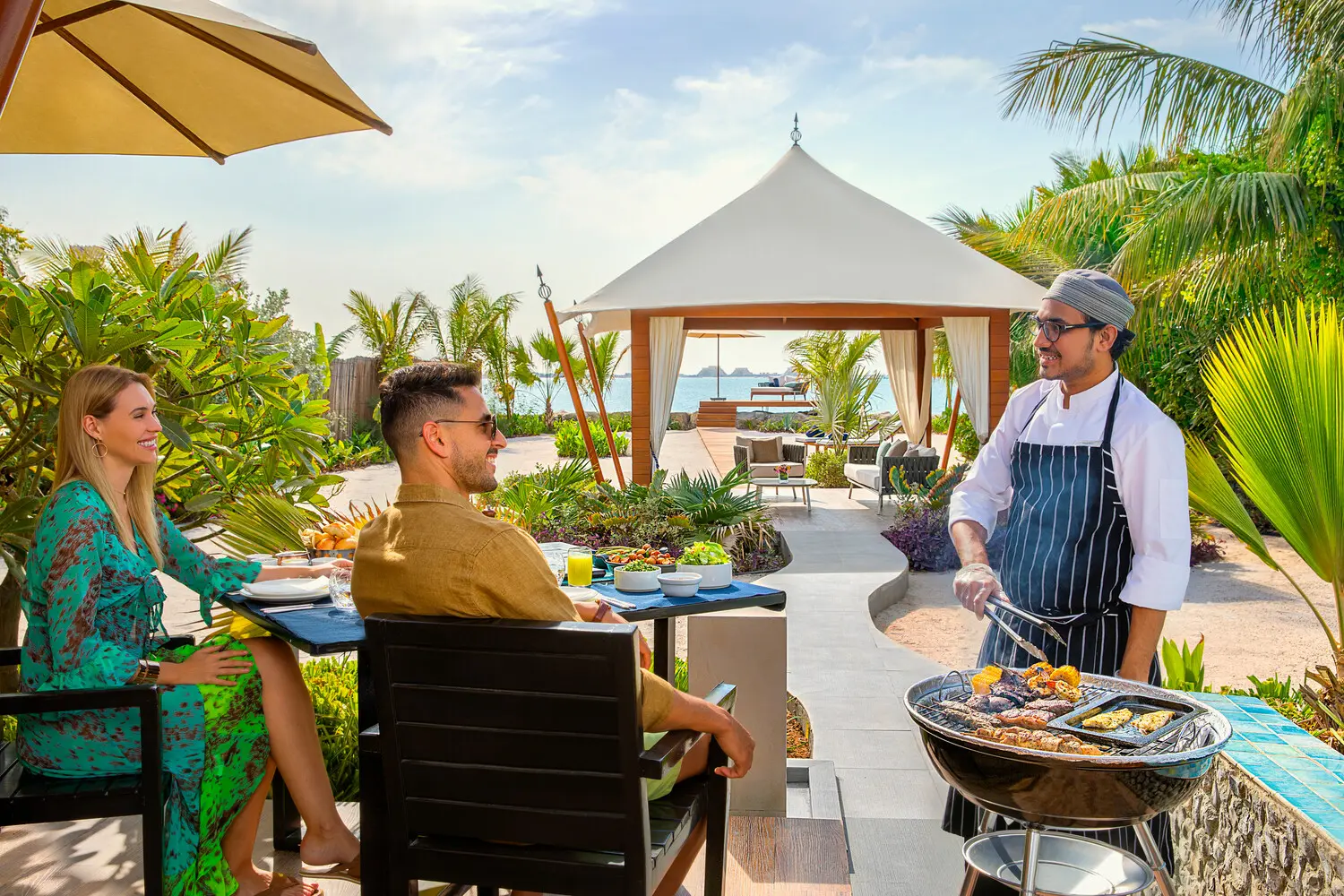 the ritzcarlton al hamra beach in villa dining showcasing an intimate couple dining experience within the privacy of a beachfront villa