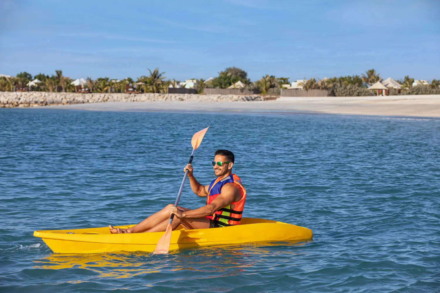 the ritzcarlton al hamra beach kayaking offering a tranquil coastal water experience along the shoreline