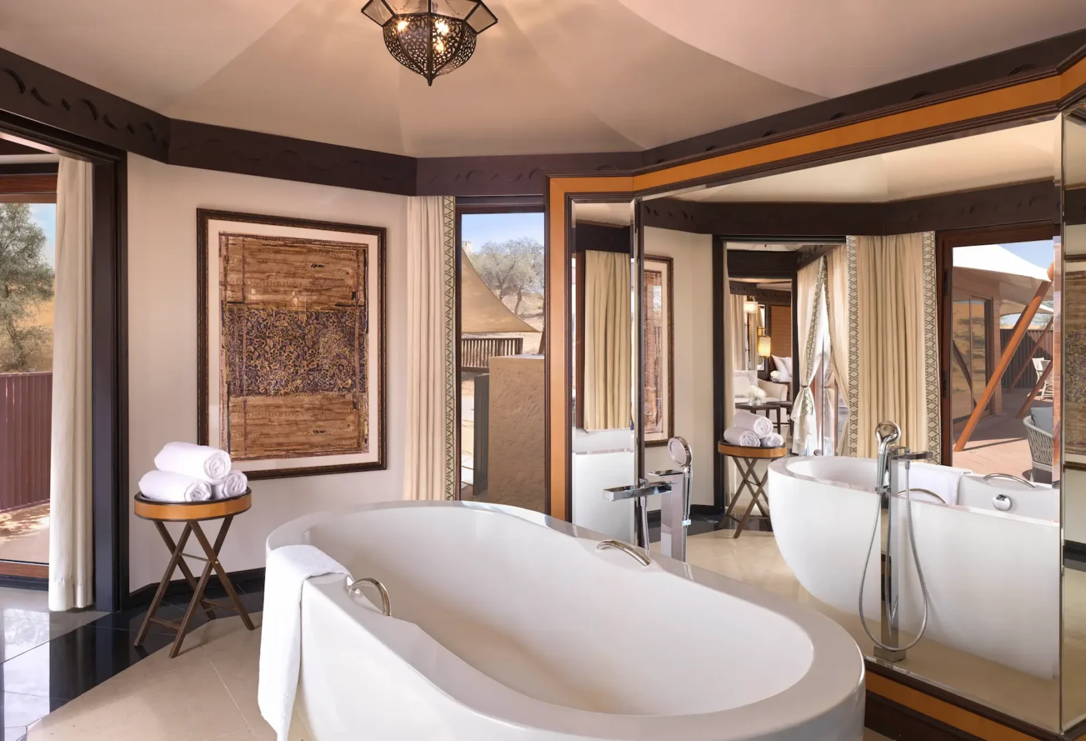 the ritzcarlton al wadi desert al khaimah villa pool bathroom with an open air bathing space overlooking the private pool