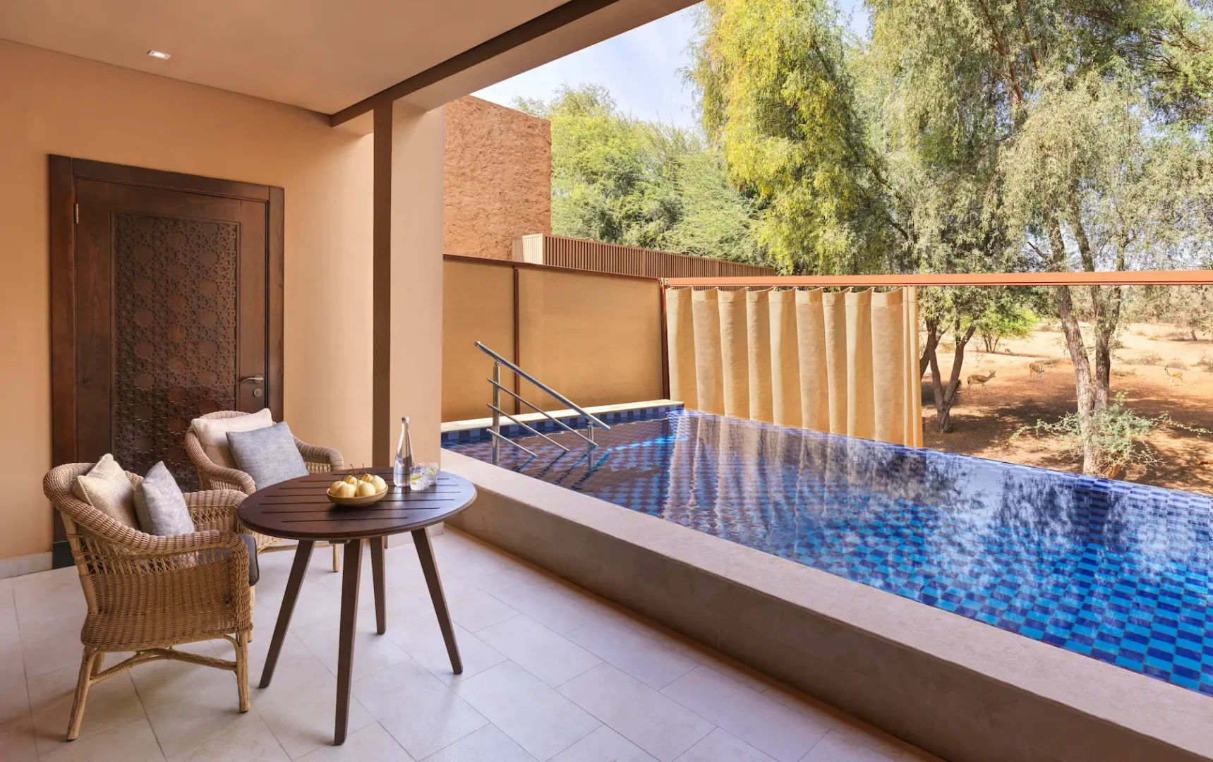 the ritzcarlton al wadi desert al rimal enclosed swimming pool offering a private pool setting within the desert surroundings