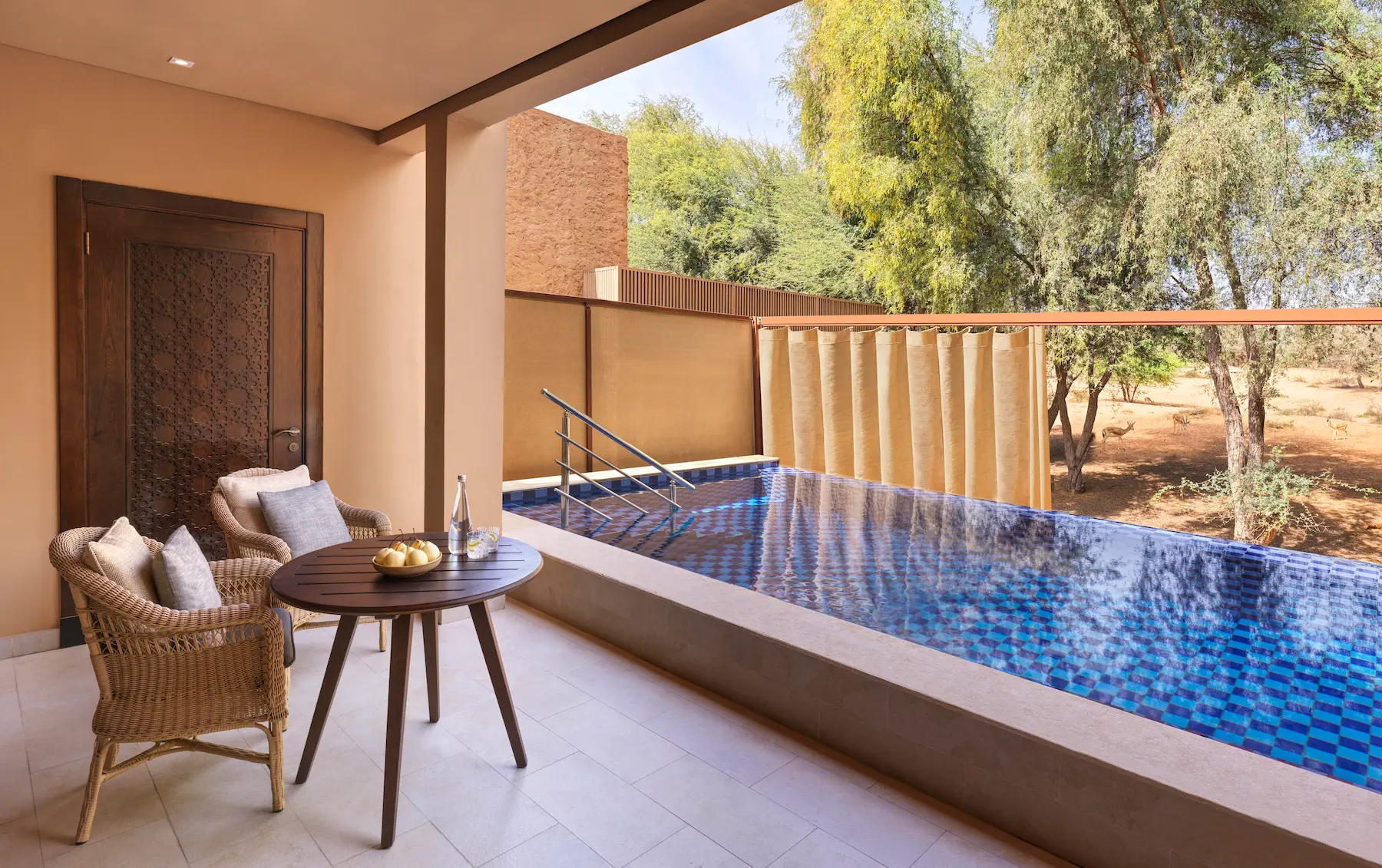 the ritzcarlton al wadi desert al rimal enclosed swimming pool offering a private pool setting within the desert surroundings