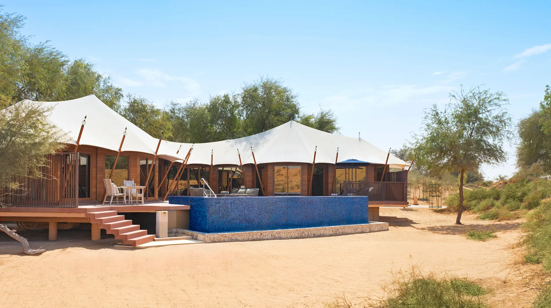 the ritzcarlton al wadi desert al sahari secluded exterior showcasing a private desert villa surrounded by tranquil natural scenery