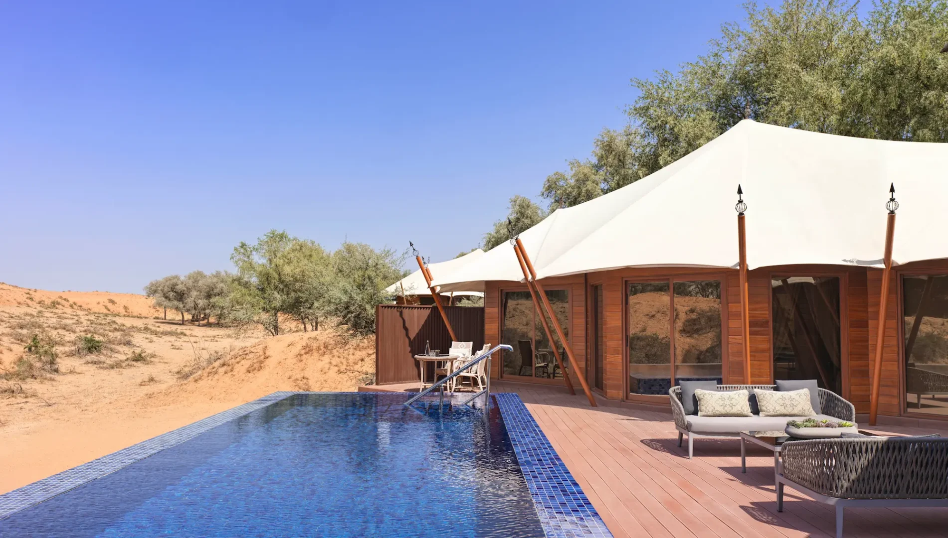 the ritzcarlton al wadi desert al sahari secluded swimming pool side with a private poolside setting surrounded by the peaceful desert landscape