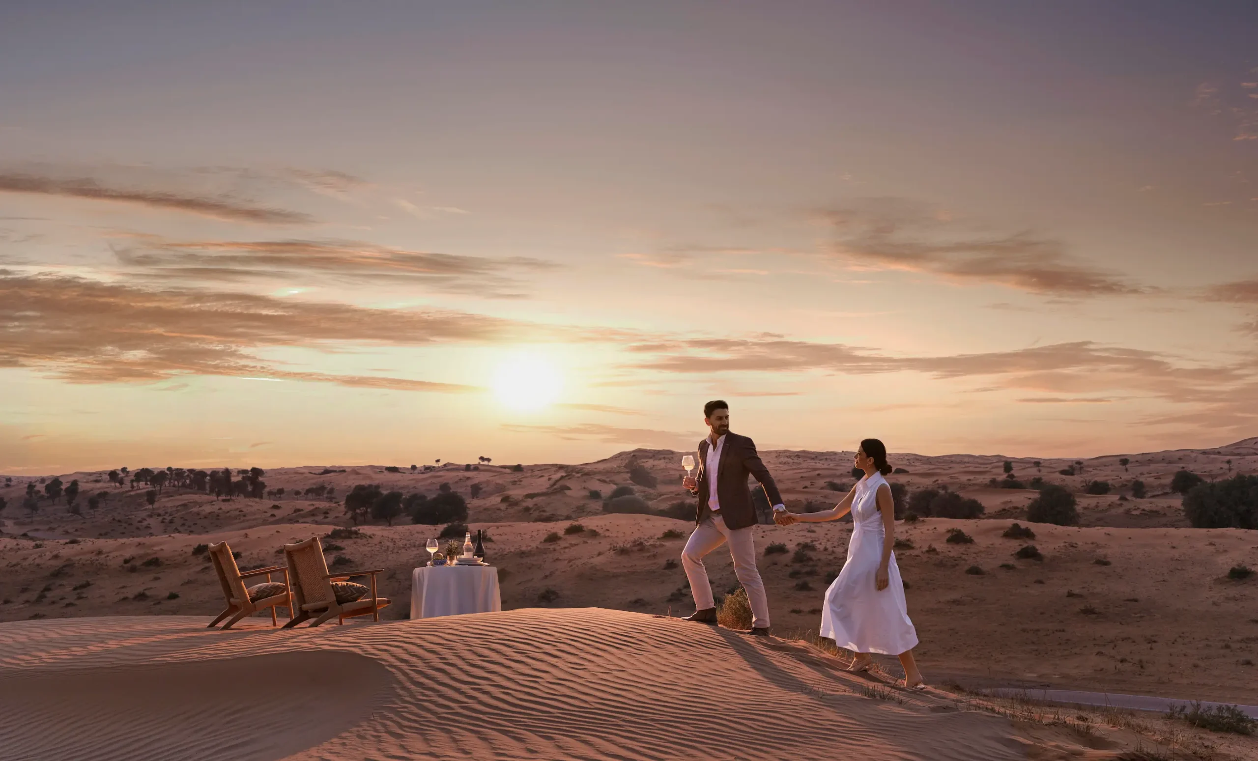 the ritzcarlton al wadi desert destination dining on a sand dune offering an intimate dining experience set against the desert landscape