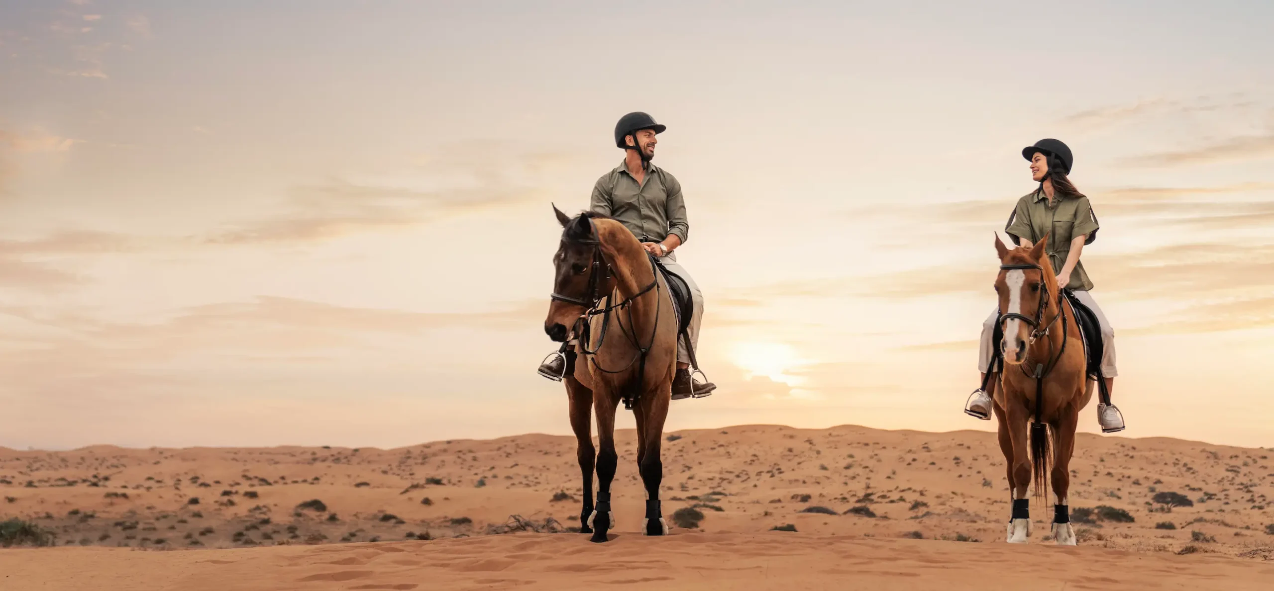 the ritzcarlton al wadi desert equestrian experience showcasing horses within a serene desert setting