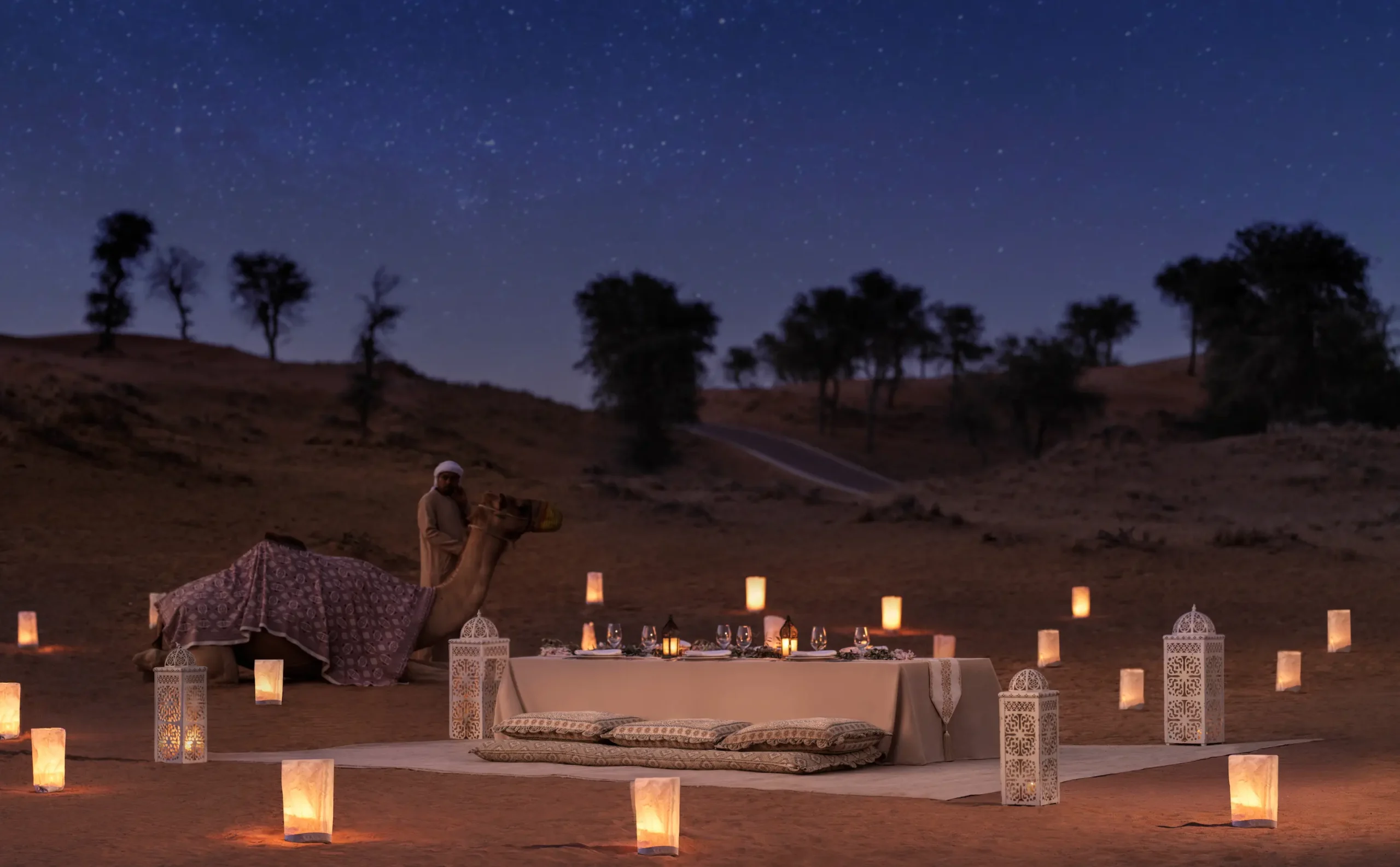the ritzcarlton al wadi desert oasis dining showcasing an elegant open air dining setting surrounded by the desert landscape