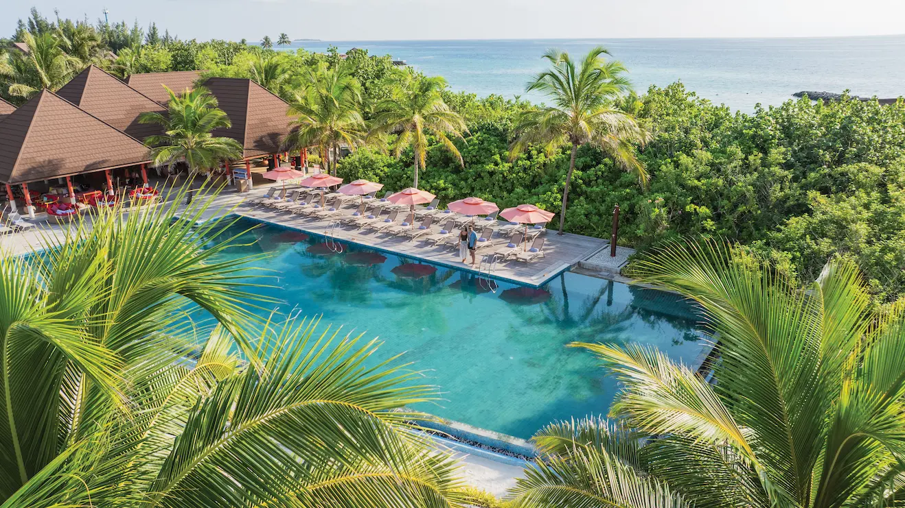 aerial view of bay rouge poolside dining at varu by atmosphere maldives along the tropical shoreline