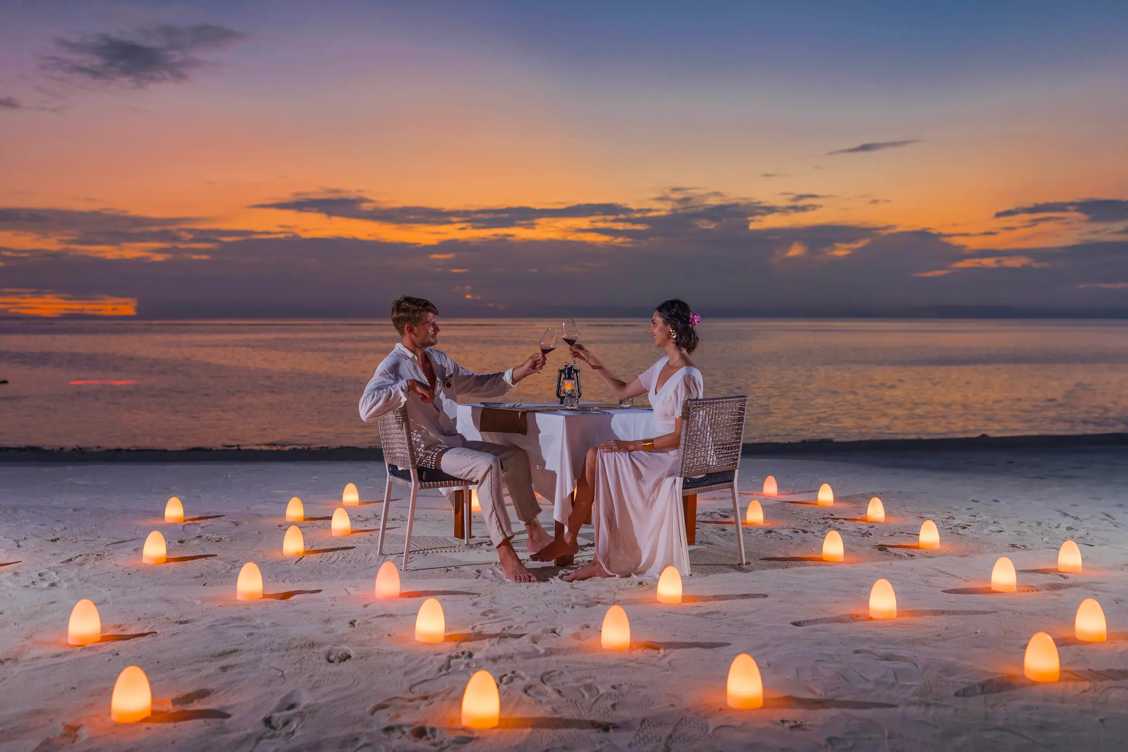 sunset dinner experience at varu by atmosphere maldives set against ocean views and golden skies