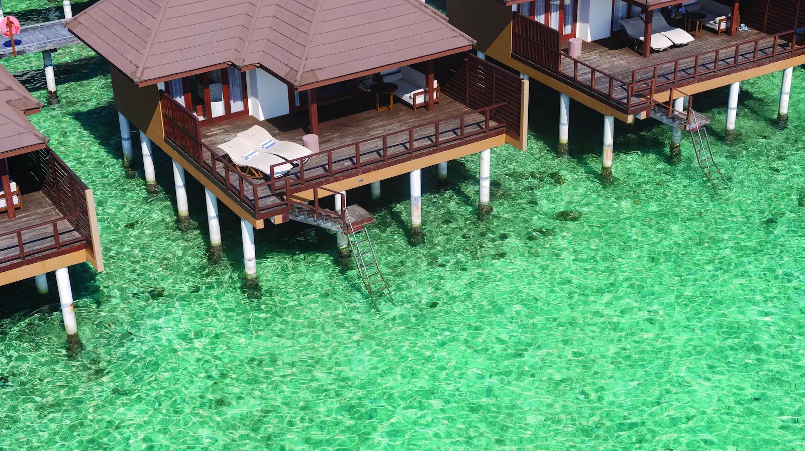 luxury water villa exterior at varu by atmosphere maldives set over a turquoise lagoon