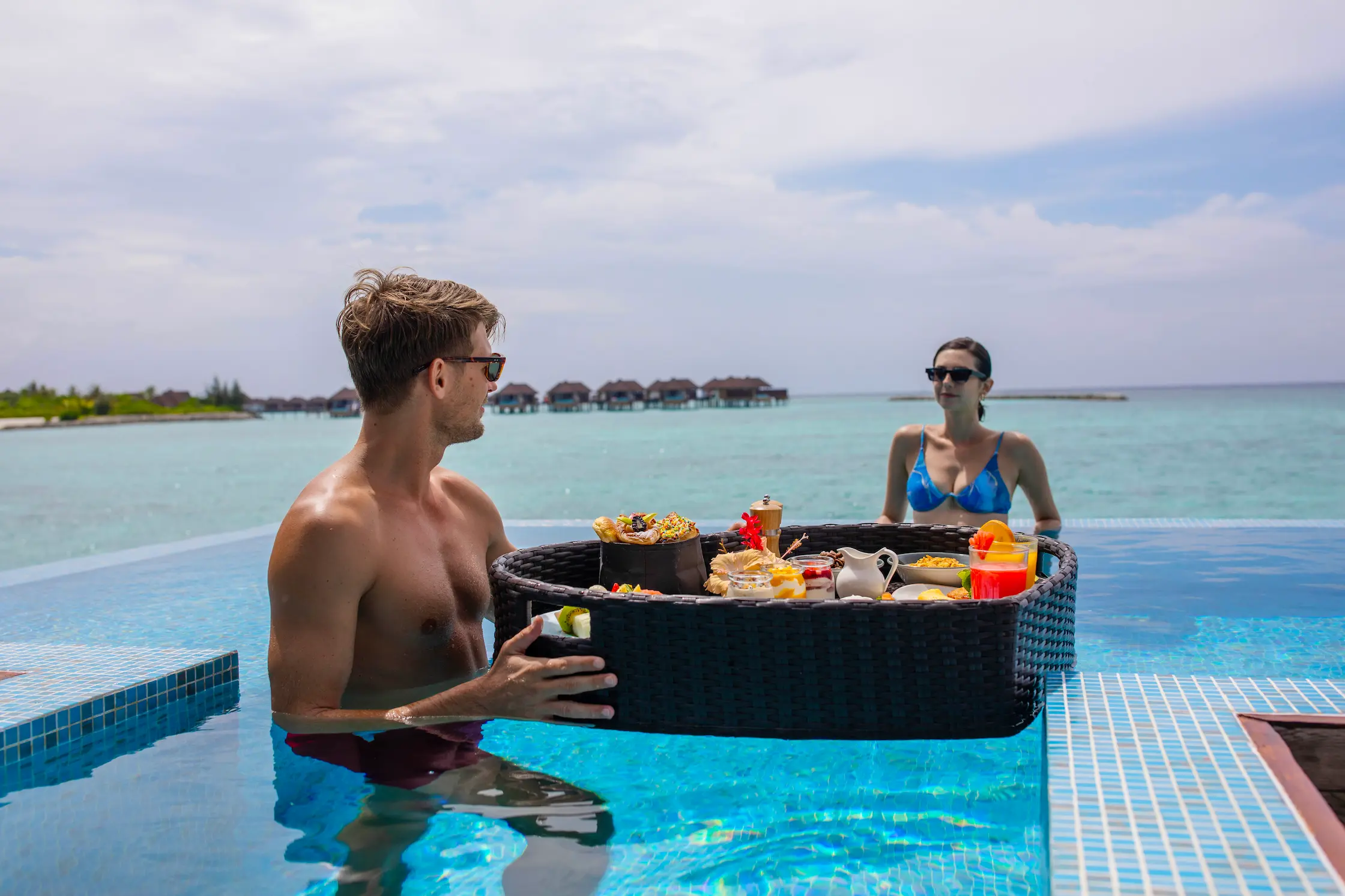 floating breakfast experience in a water villa at varu by atmosphere maldives overlooking the turquoise lagoon