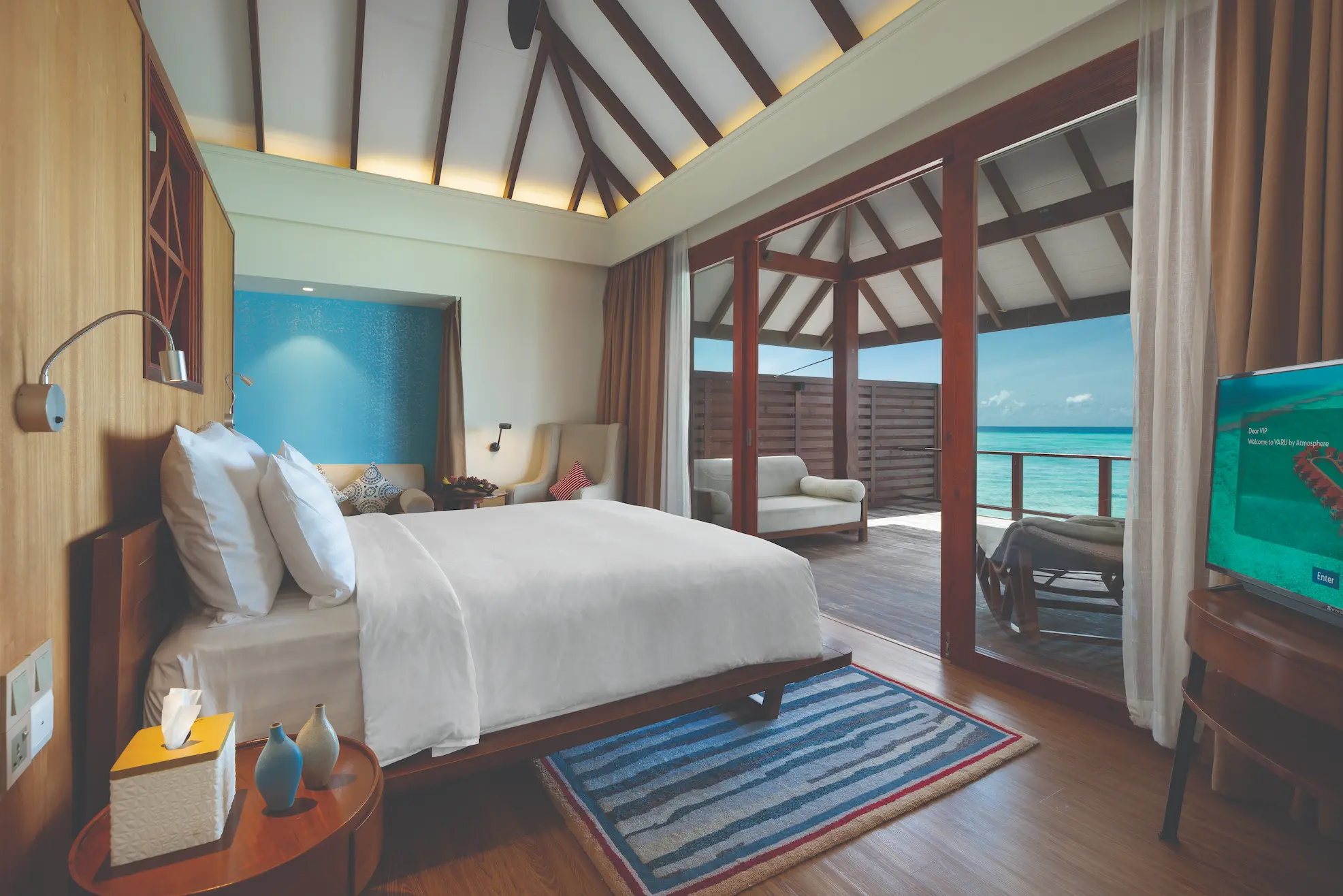 luxury water villa interior bedroom at varu by atmosphere maldives with elegant contemporary design