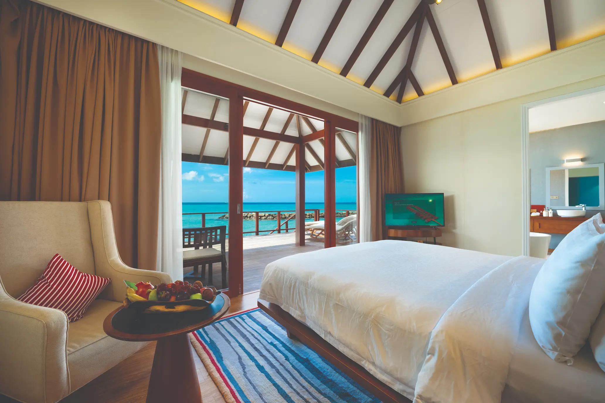 luxury water villa interior at varu by atmosphere maldives with elegant contemporary design