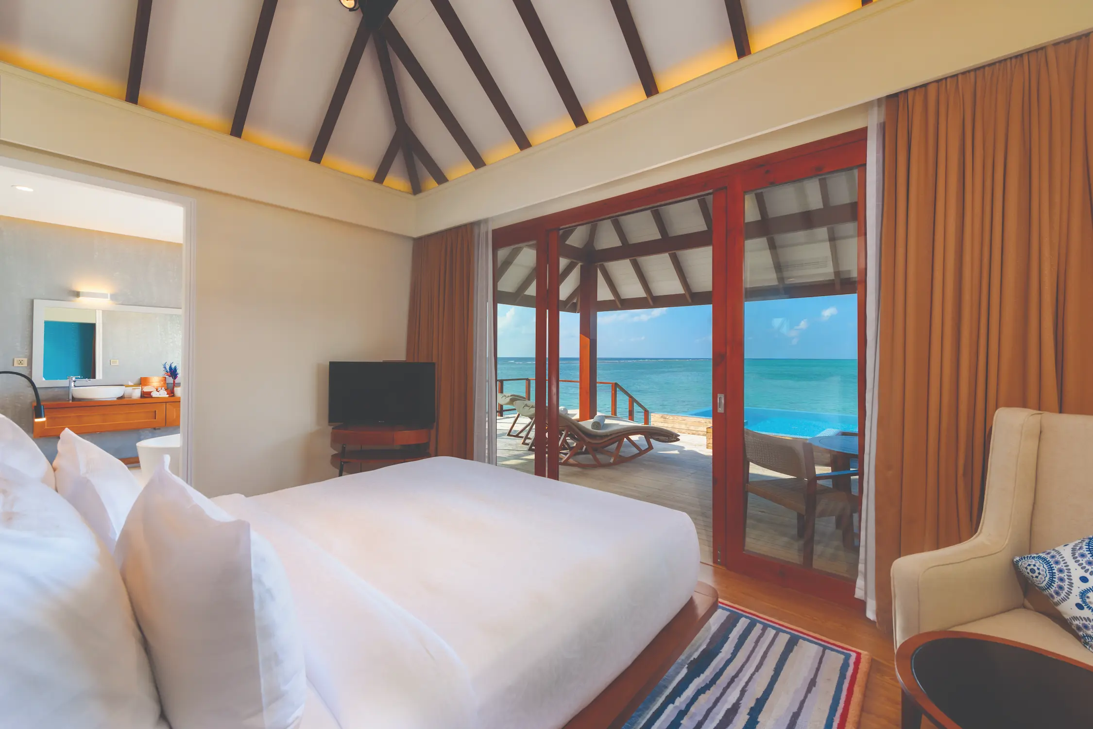 luxury water villa with private pool bedroom view at varu by atmosphere maldives overlooking the ocean