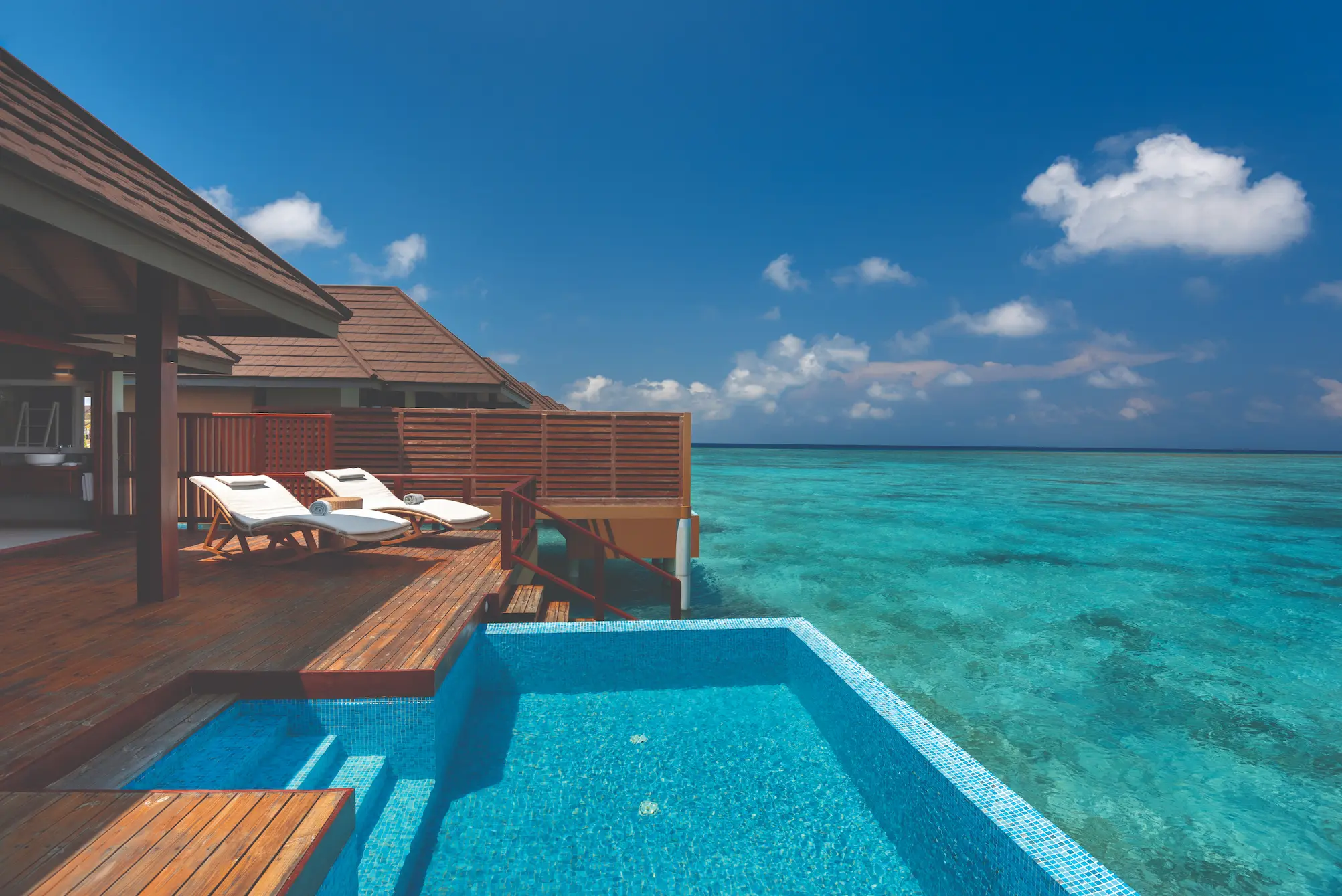 luxury water villa with private pool exterior view at varu by atmosphere maldives over the turquoise lagoon