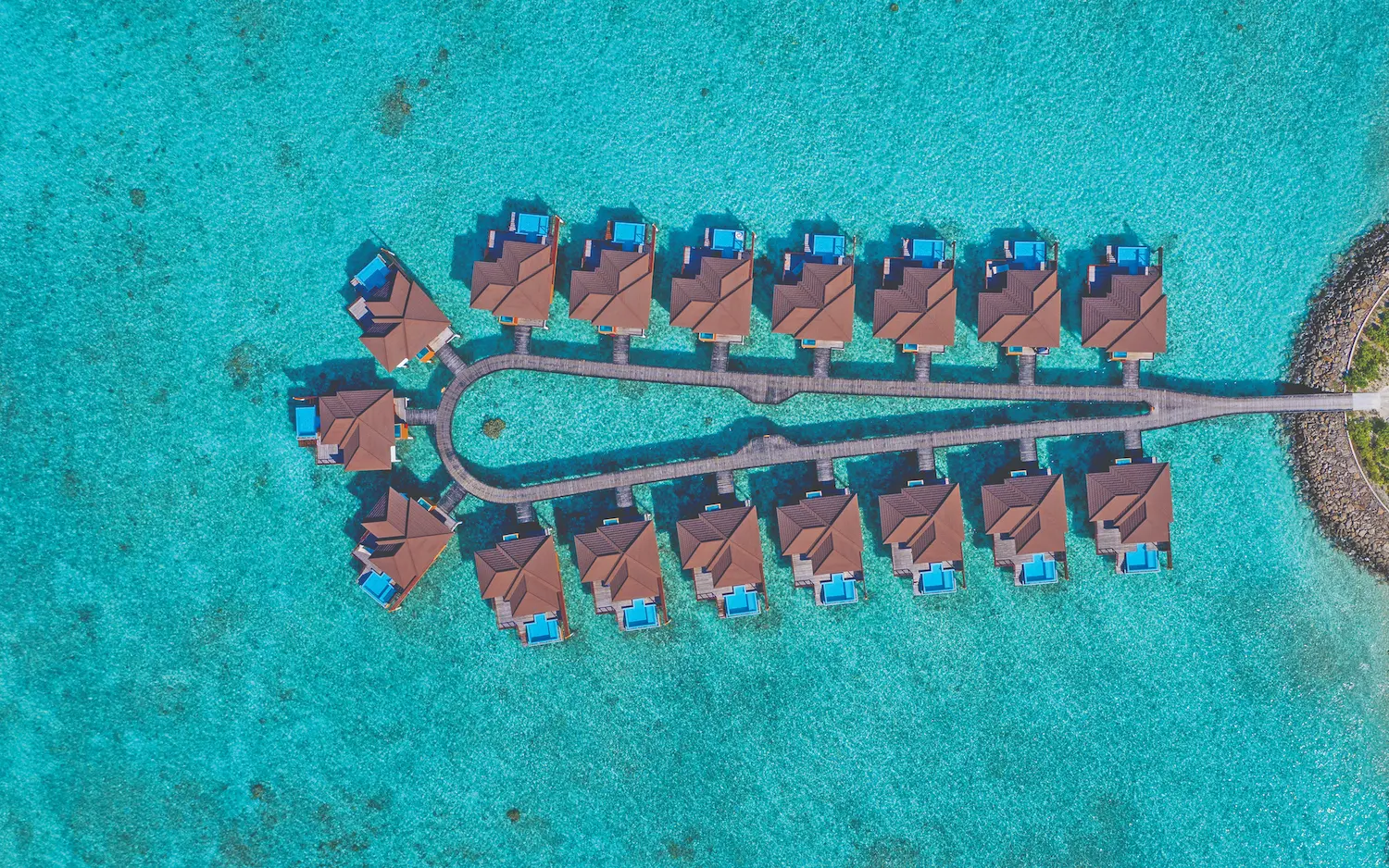luxury water villa with private pool jetty at varu by atmosphere maldives extending over the lagoon