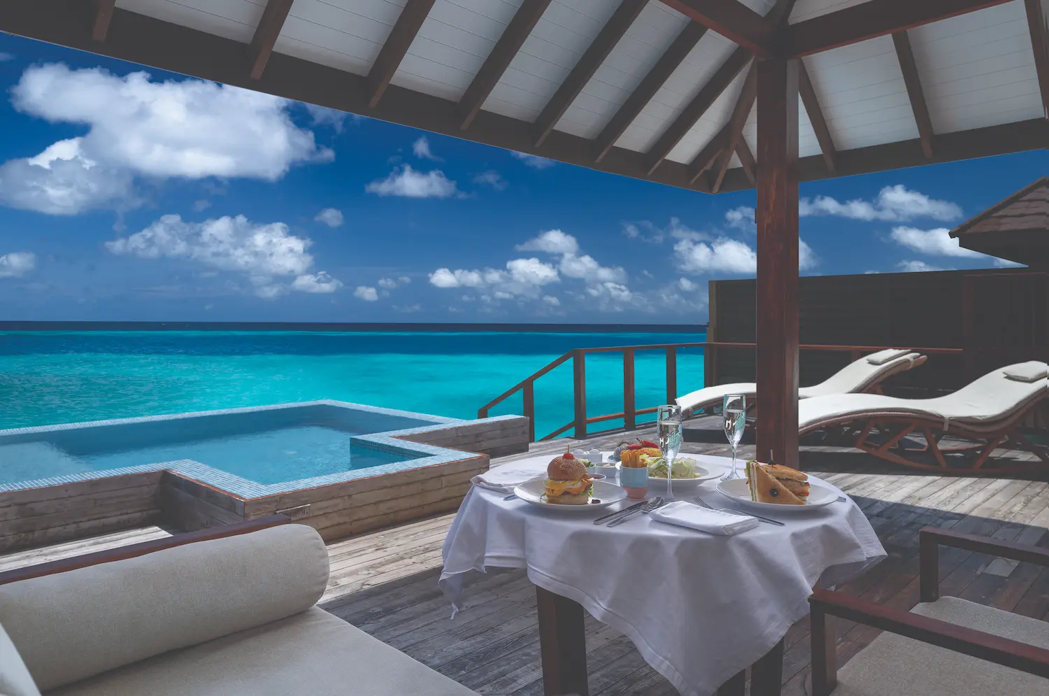 luxury in villa breakfast served at water villas at varu by atmosphere maldives over the lagoon
