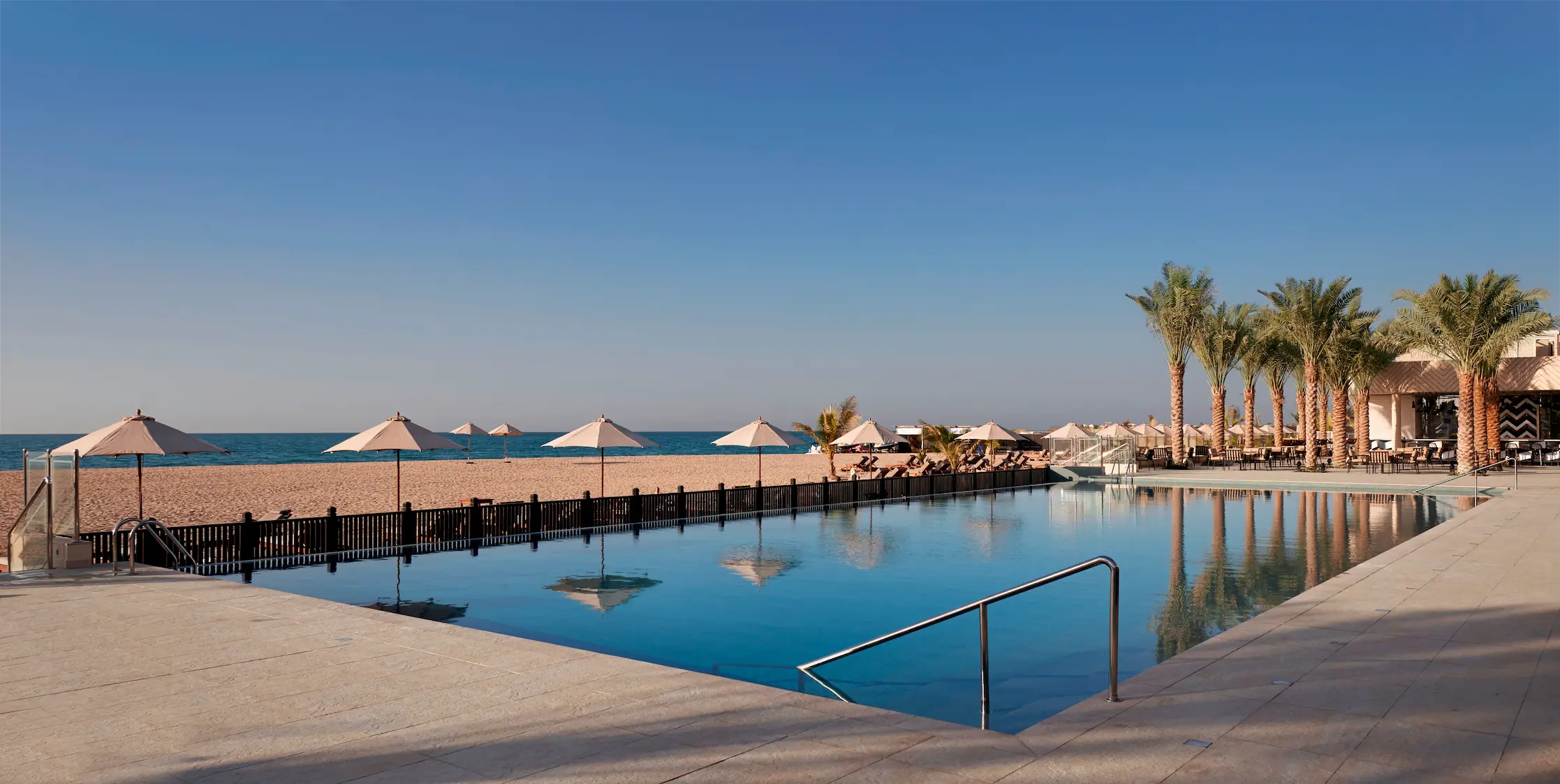 waldorf astoria ras al khaimah sunset beach club and lounge offering relaxed beachfront dining and sunset views
