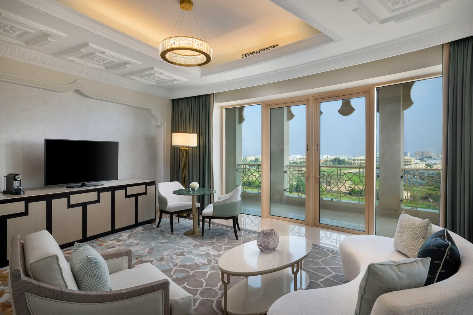 waldorf astoria ras al khaimah two queen beds premier golf course view room living room and balcony with views of the greens
