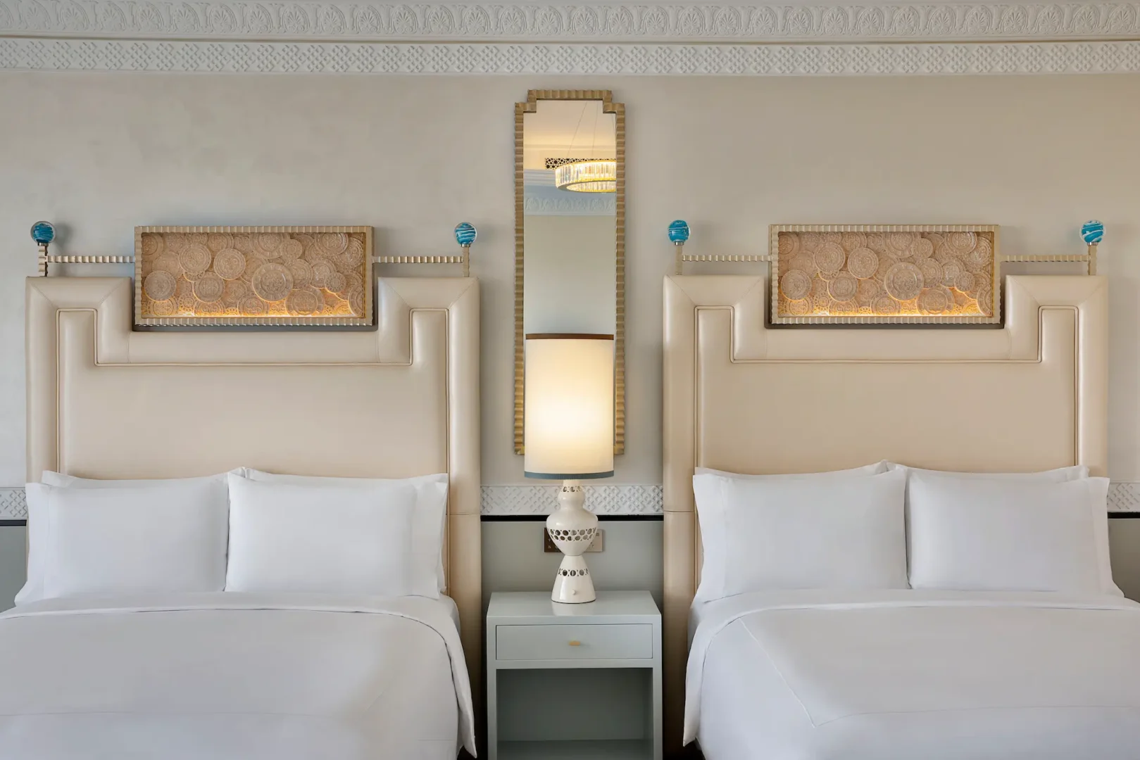 waldorf astoria ras al khaimah two queen beds premier golf course view room queen bed detail with refined luxury styling