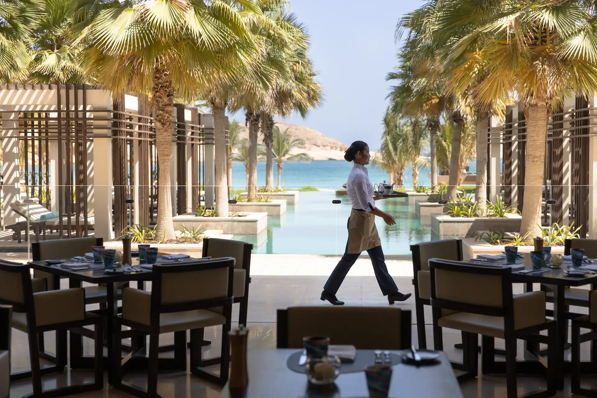 peridot restaurant at jumeirah muscat bay oman featuring international buffet dining elegant interiors and resort breakfast and dinner setting