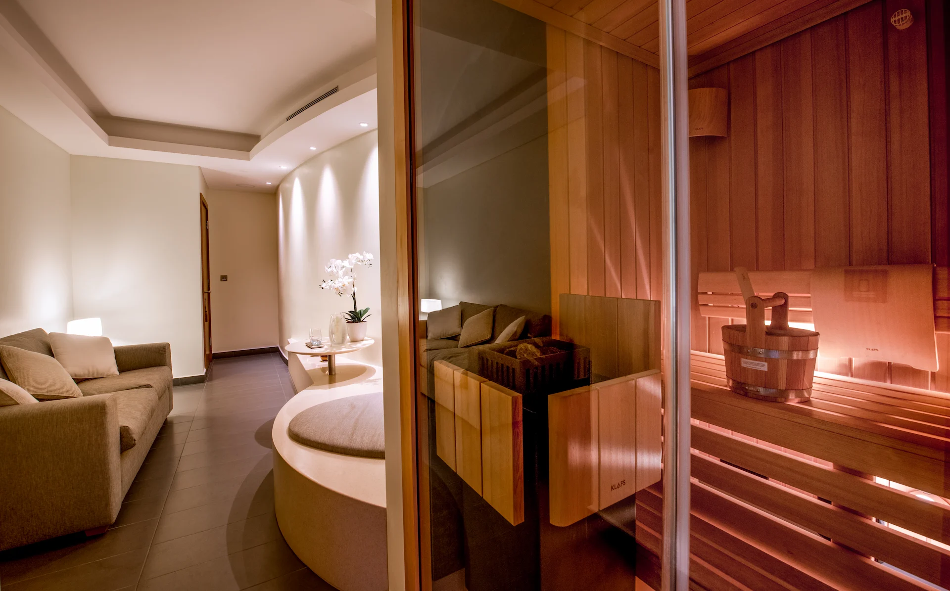 kempinski hotel muscat oman spa wellness center treatment rooms sauna relaxation area luxury resort spa interior