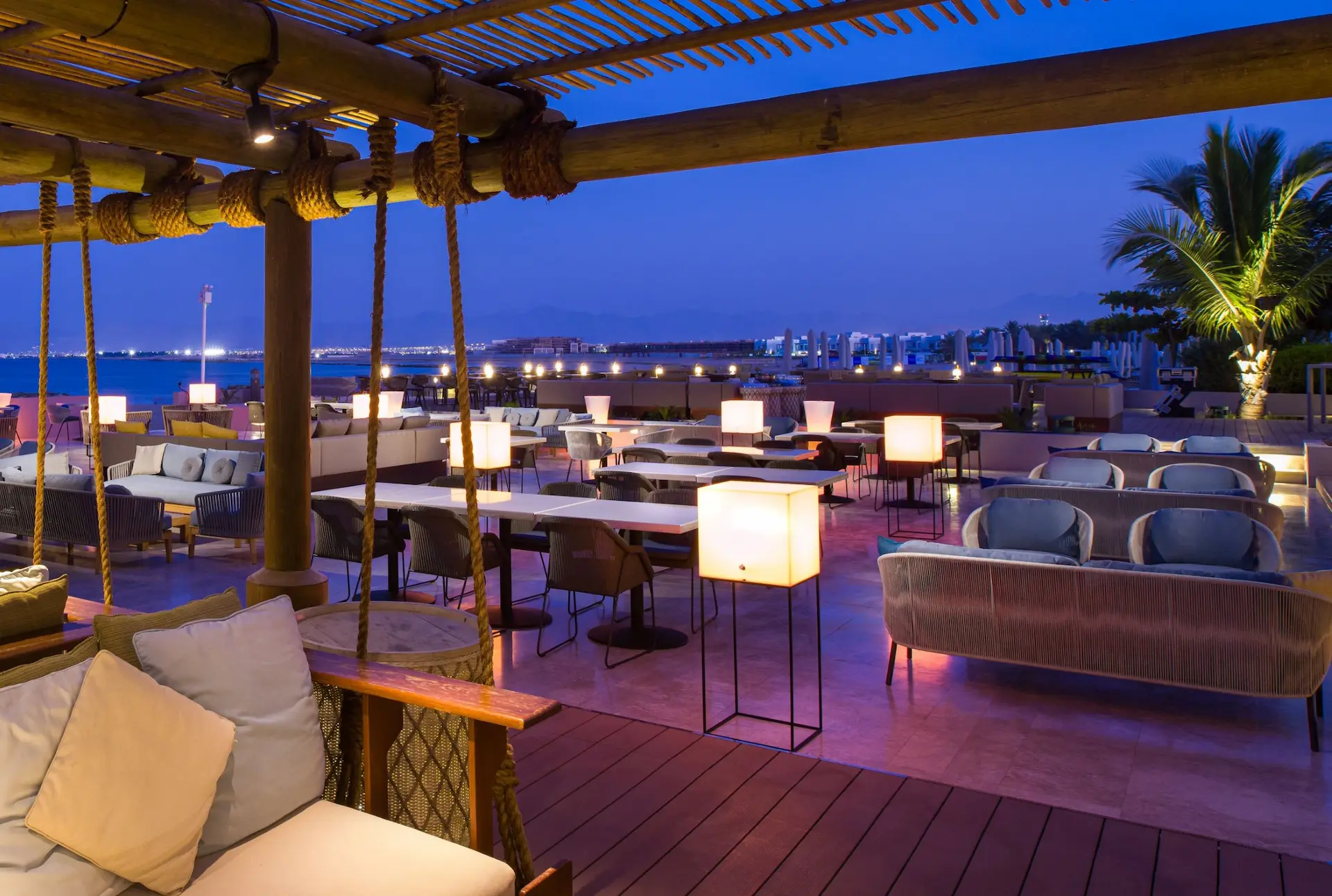 kempinski hotel muscat oman zale terrace outdoor lounge seating ocean view sunset terrace resort dining ambiance night lights