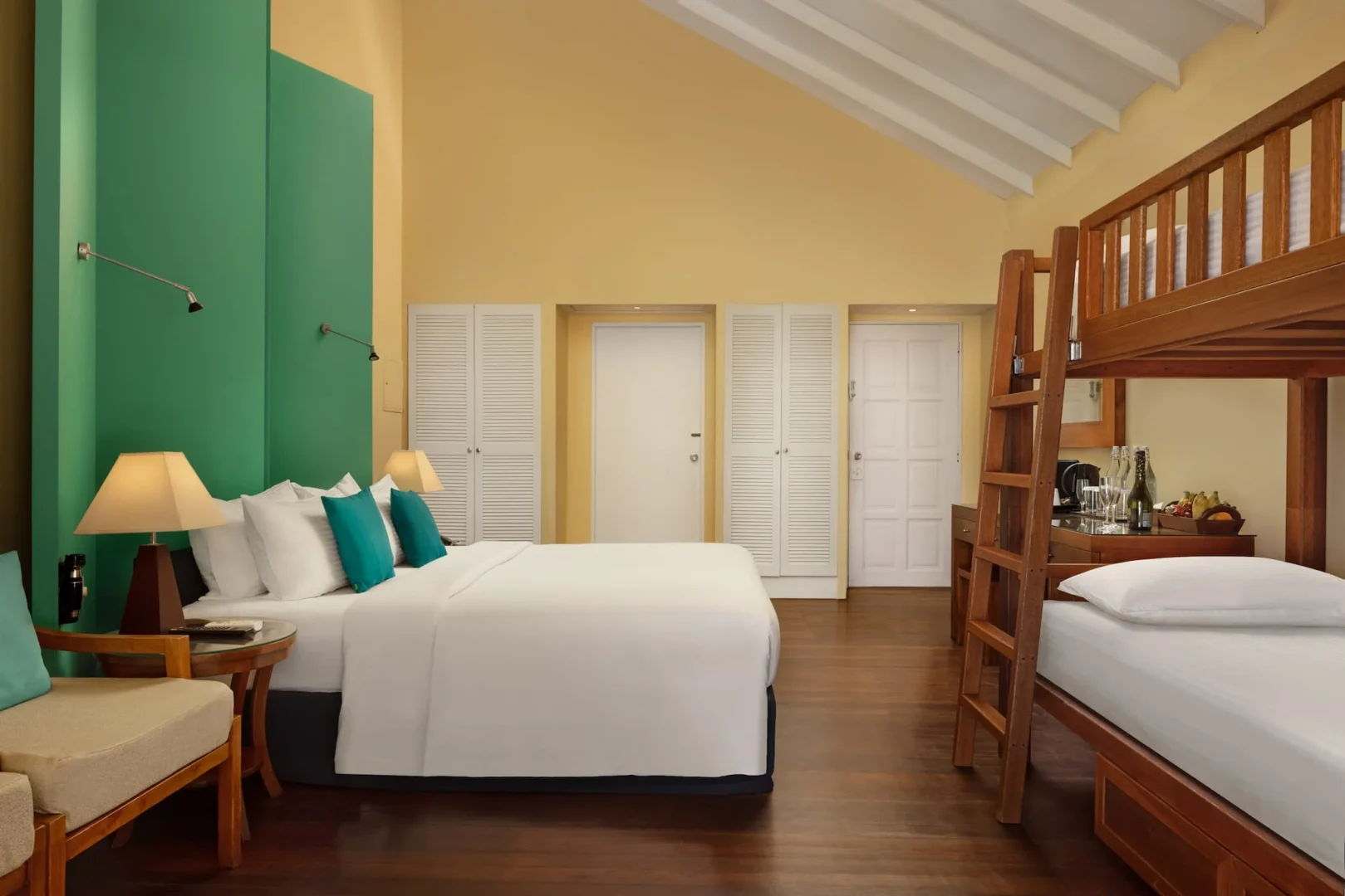 adaaran select meedhupparu one bedroom family beach villa king bed bedroom with bright coastal interiors maldives