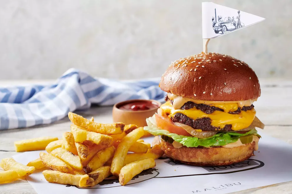 atlantis the palm malibu food american burger featuring a gourmet beef burger with premium ingredients and vibrant presentation in a relaxed luxury dining setting in dubai