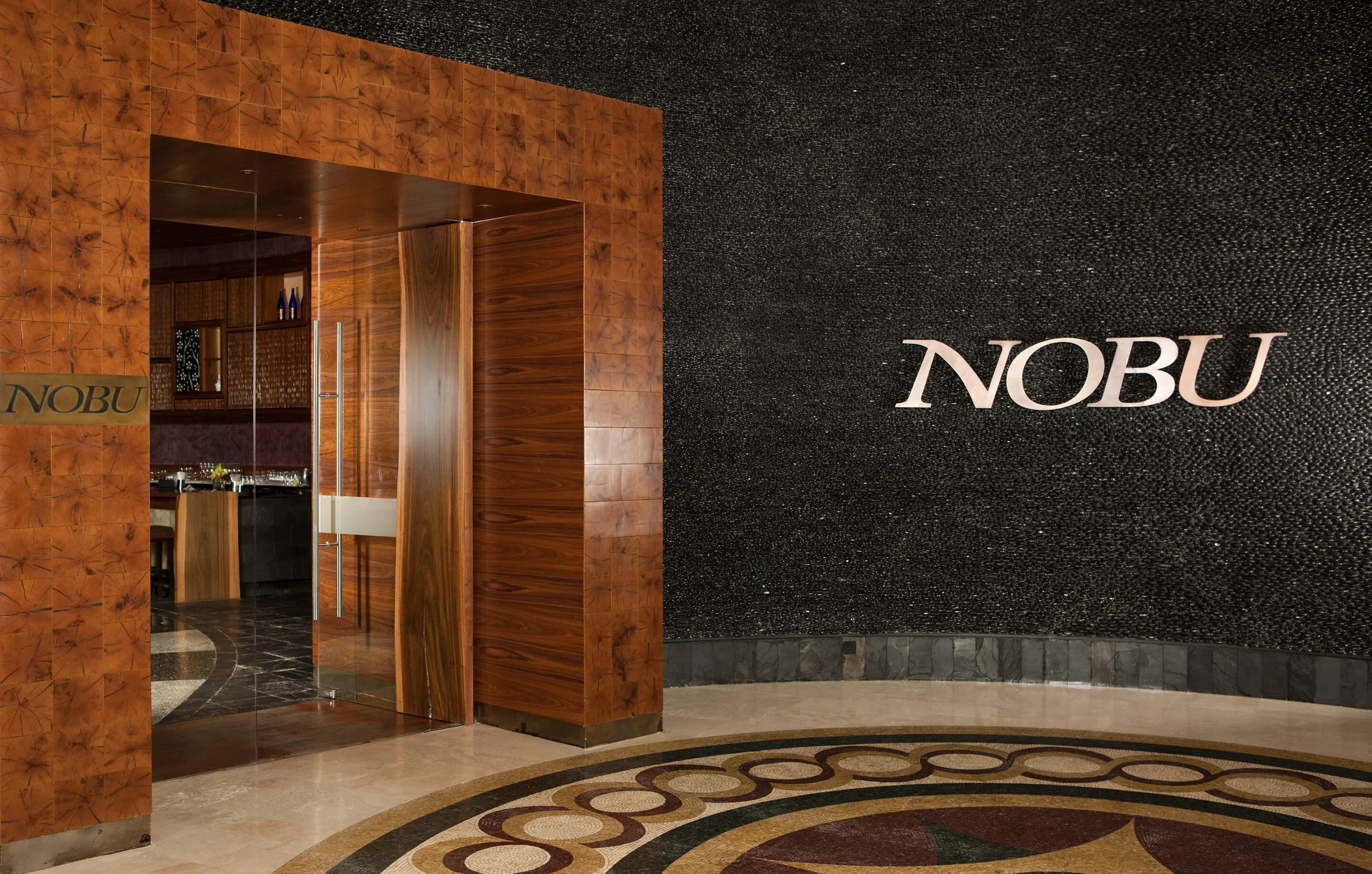 atlantis the palm nobu entrance featuring striking architectural design, ambient lighting and a sophisticated luxury dining atmosphere in dubai