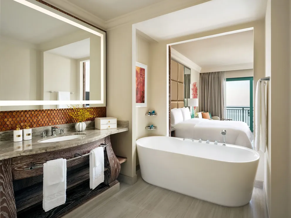 atlantis the palm ocean view room king bed bedroom with elegant interiors, plush seating area and expansive views across the arabian gulf in dubai