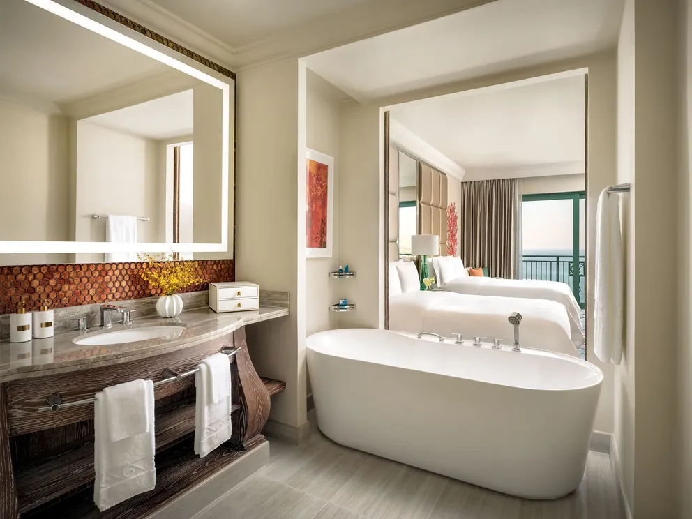 atlantis the palm ocean view room with queen twin beds and bathroom featuring marble finishes, elegant design and serene views across the arabian gulf in dubai