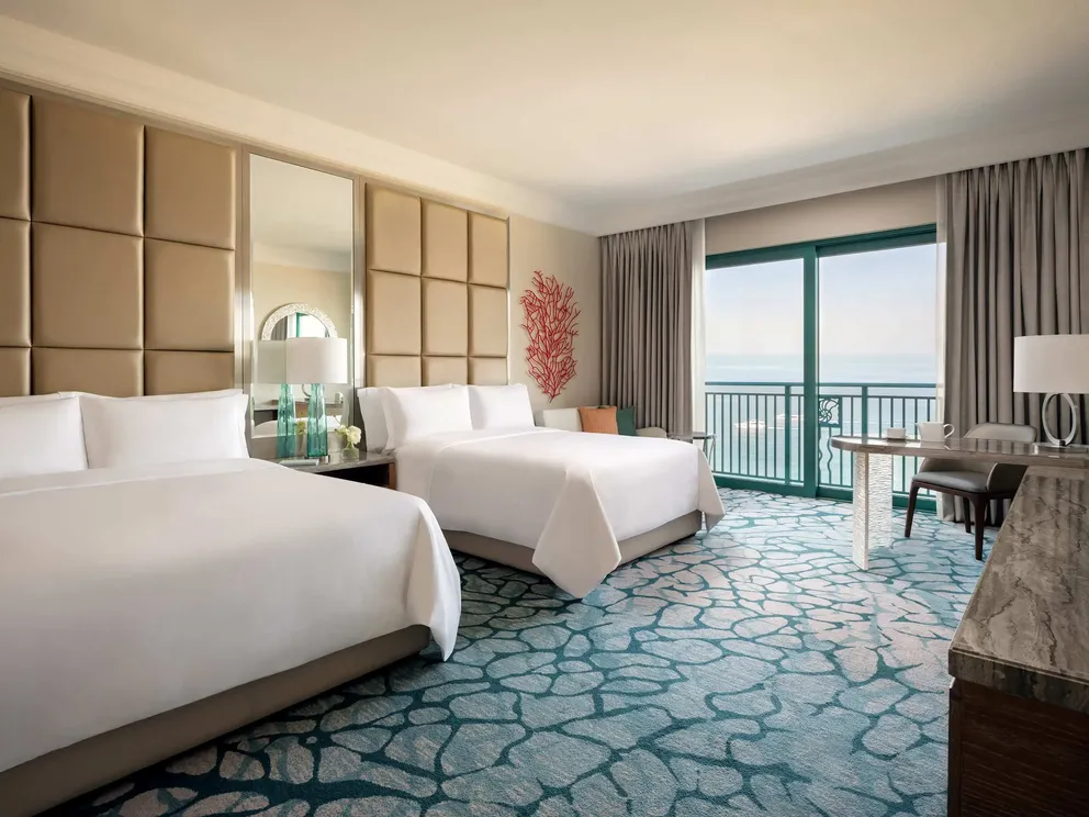atlantis the palm ocean view room with queen twin beds featuring elegant interiors, soft furnishings and sweeping views across the arabian gulf in dubai