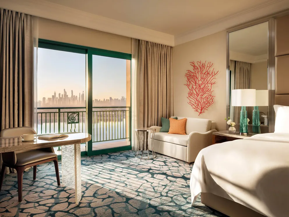 atlantis the palm palm view room balcony overlooking dubai skyline with elegant outdoor seating and luxury coastal atmosphere