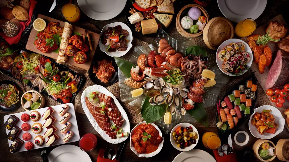 atlantis the palm saffron food spread featuring an extensive selection of international cuisine with vibrant presentation in a lively luxury dining setting in dubai