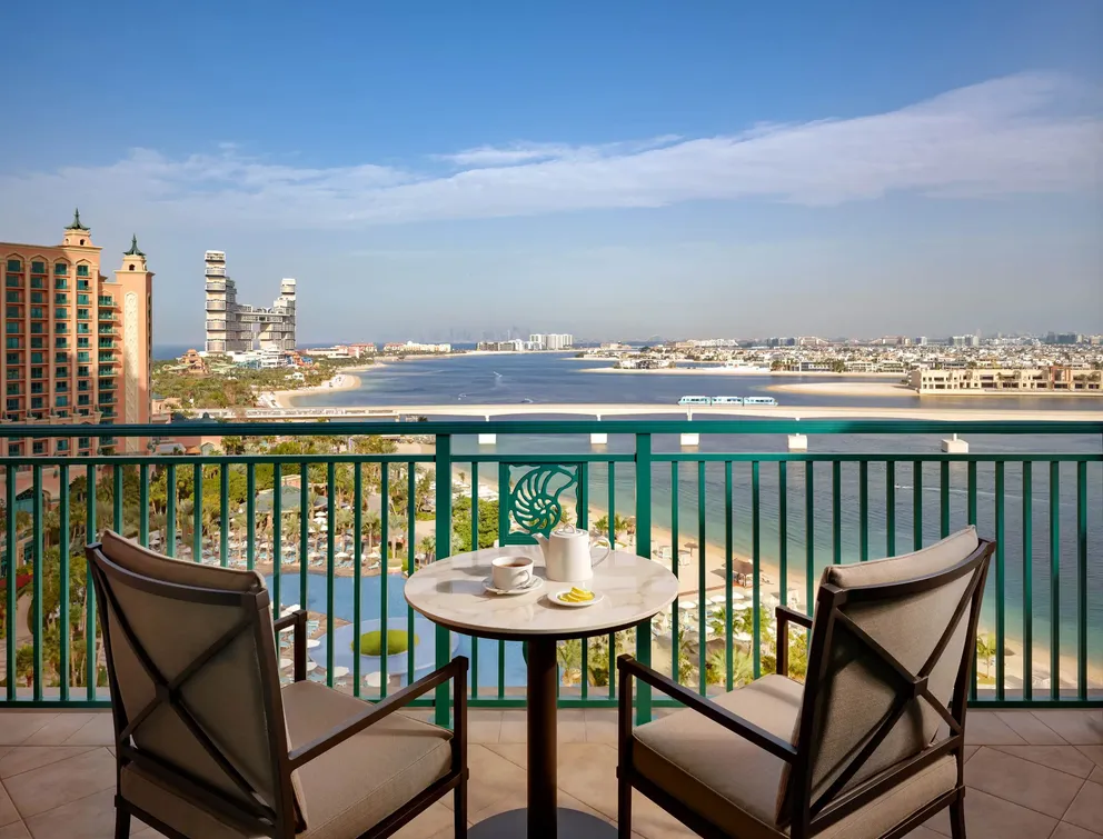 atlantis the palm skyline suite balcony with elegant outdoor seating and panoramic views across dubai skyline in a refined luxury setting