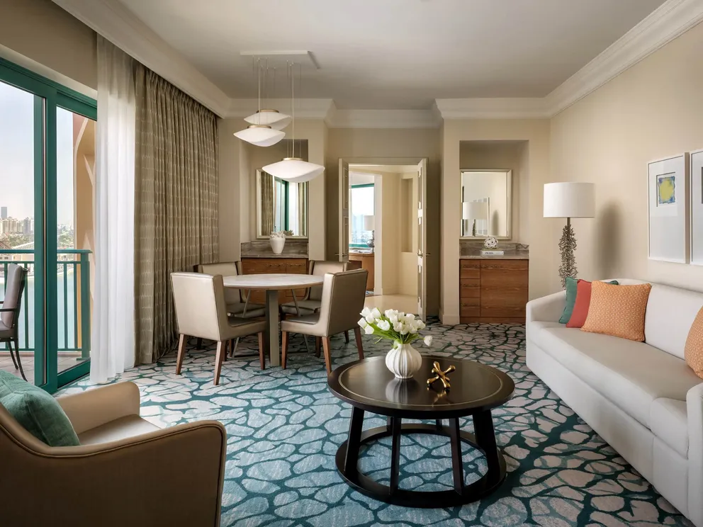 atlantis the palm skyline suite living area with spacious layout, elegant furnishings and panoramic views across dubai skyline in a refined luxury setting
