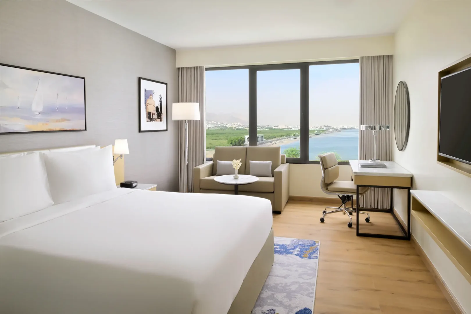 crowne plaza muscat standard sea view room oman elegant interiors overlooking the city skyline
