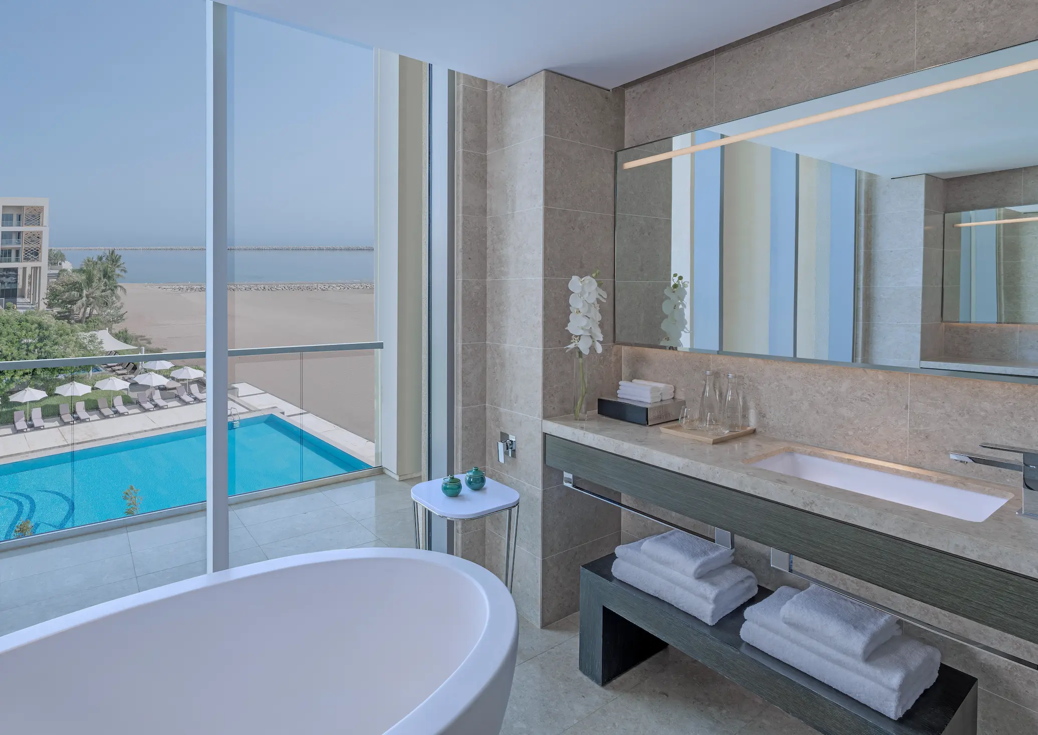 kempinski hotel muscat muscat deluxe sea view suite bathroom with elegant marble finishes and luxury bathing amenities