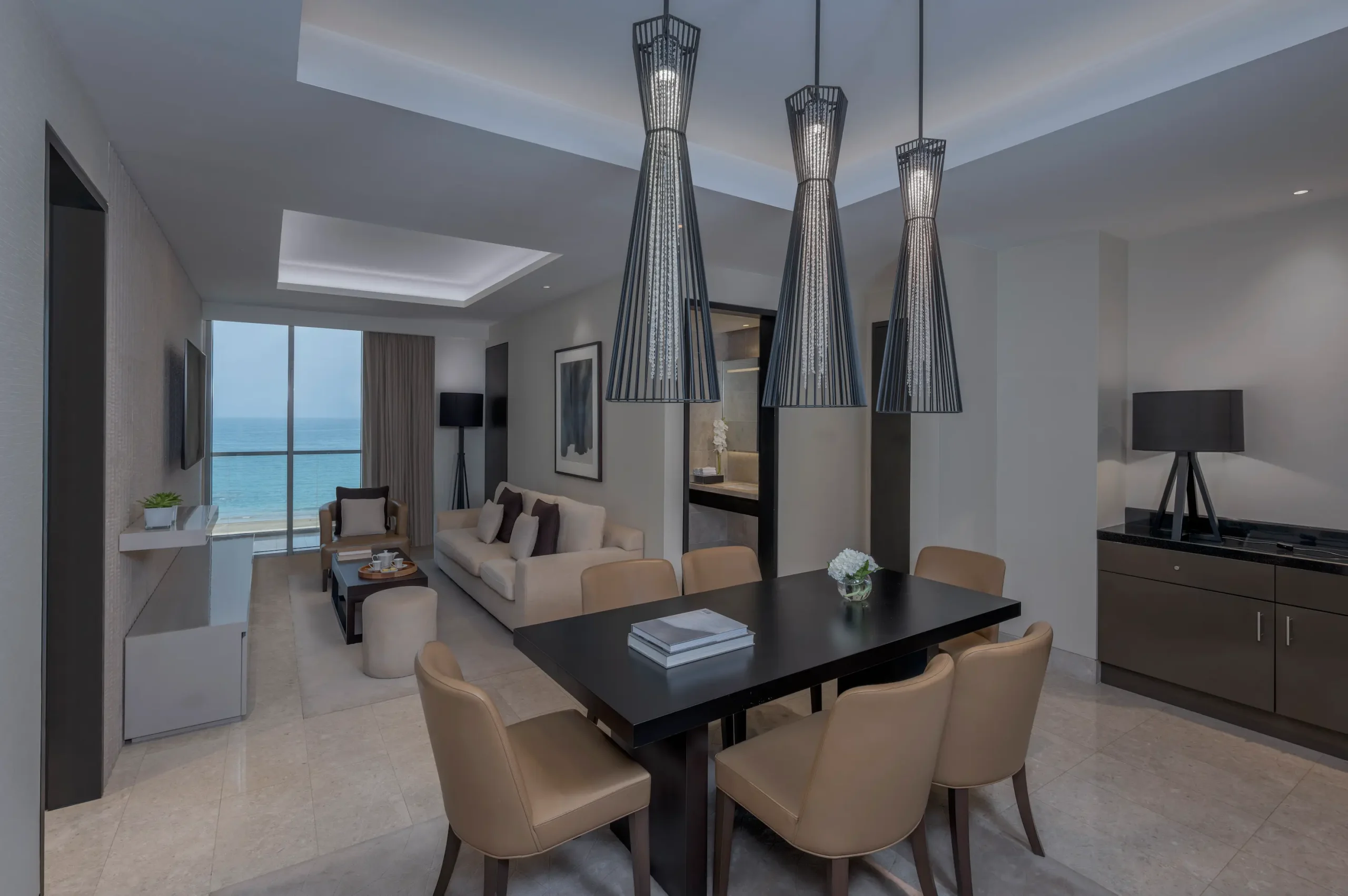 kempinski hotel muscat deluxe sea view suite dining area with elegant table setting and beautiful sea views