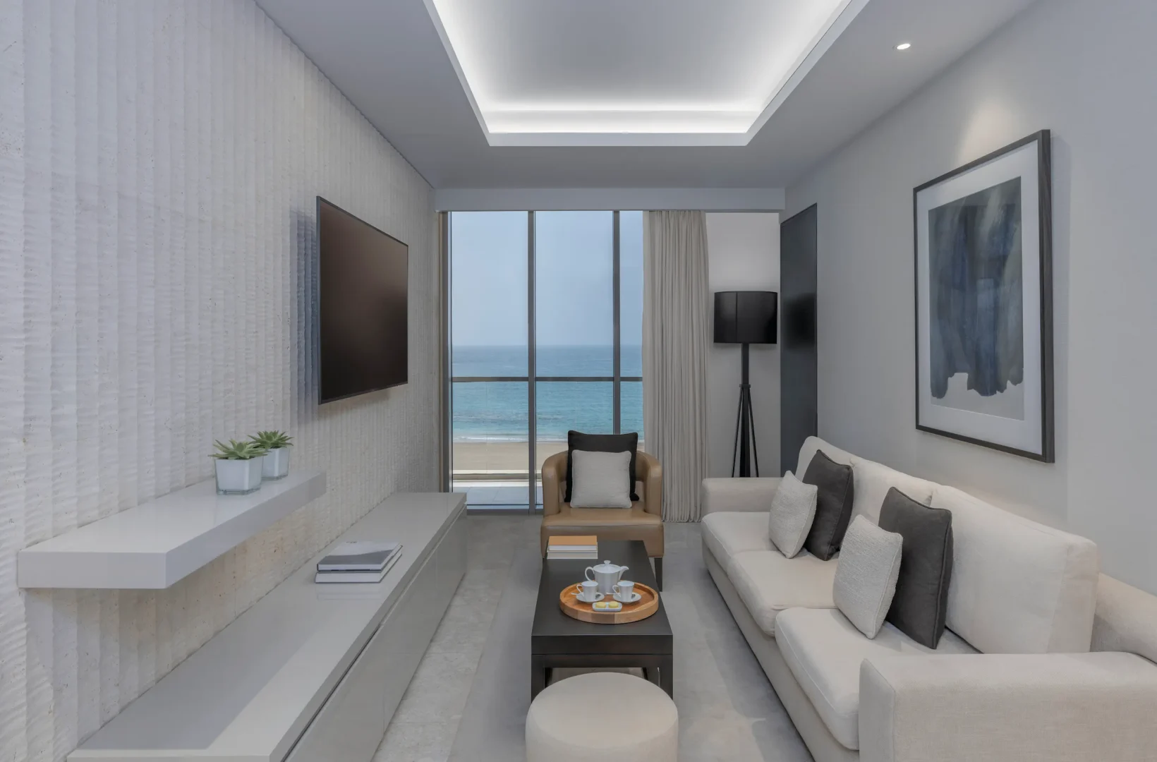 kempinski hotel muscat muscat deluxe sea view suite living room with elegant seating area and panoramic sea views